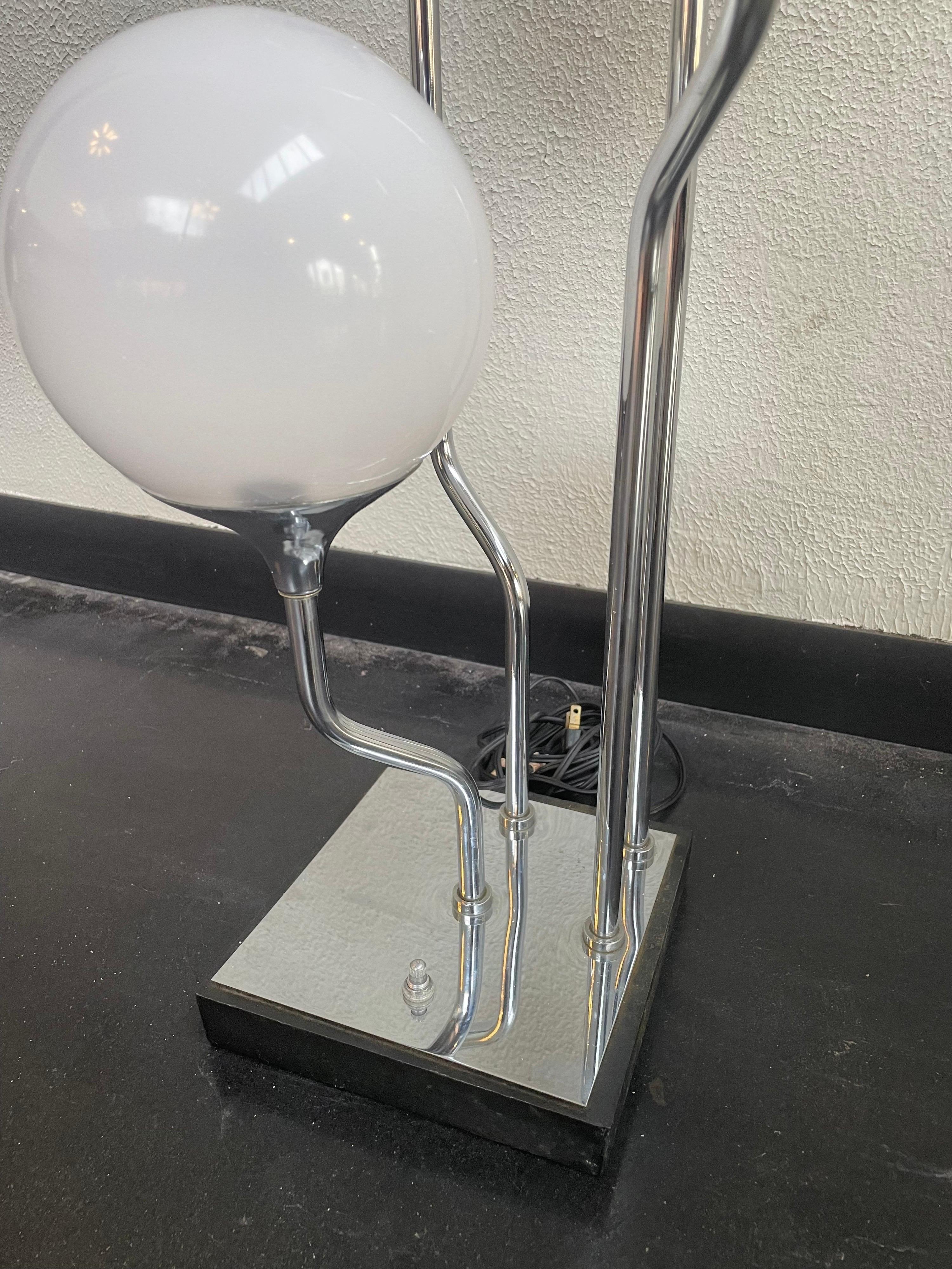 1970s Chrome table lamp with 4 acrylic globes. 3 Way switch allows for the bottom 2, top 2, and all to be turned on. Bottom wood base with chrome top.