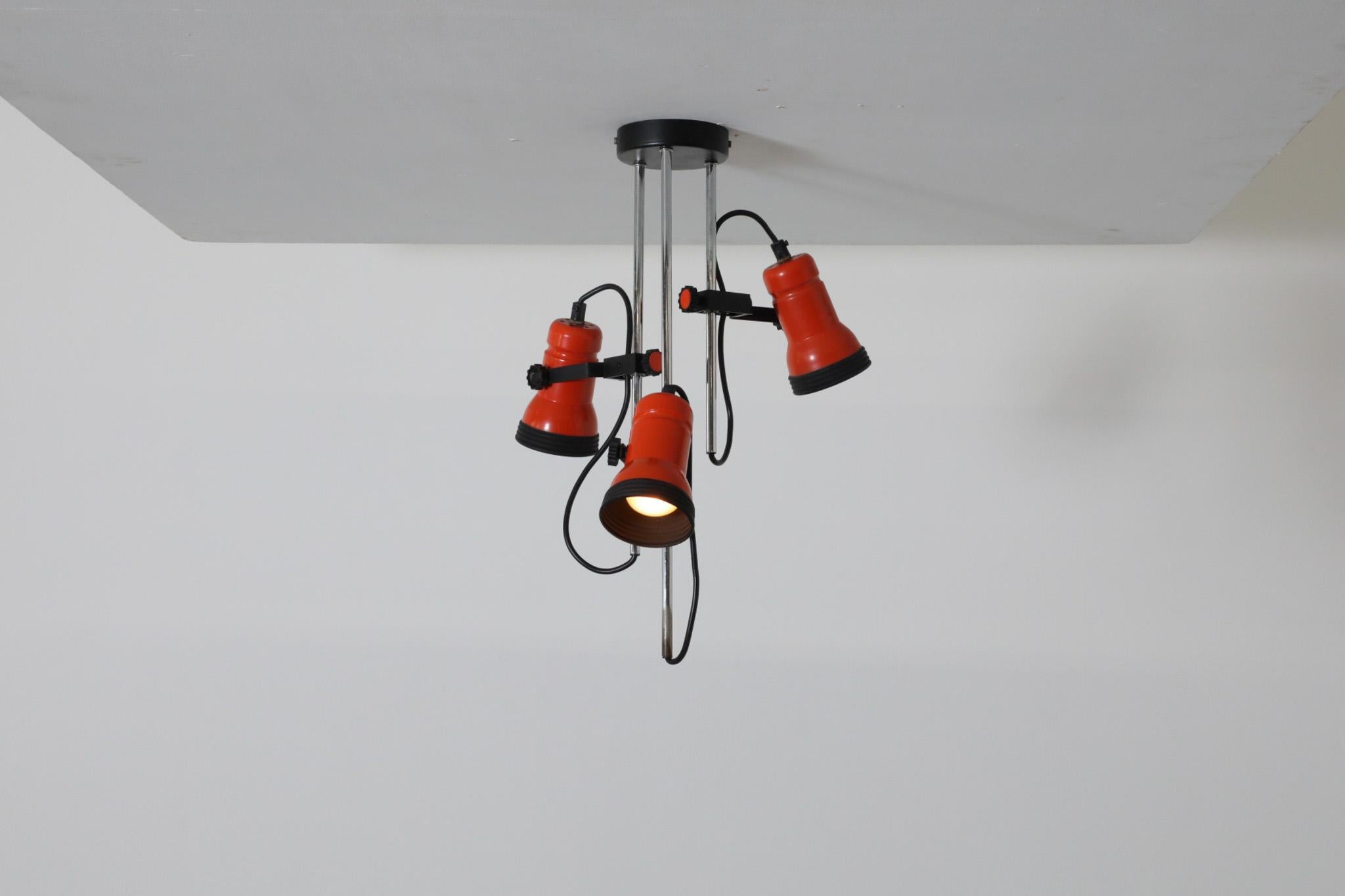 70's MOD ceiling spot light with 3 adjustable orange shades on chrome stems with black accents and black enameled hardware. In original condition with some chrome ware and consistent with age and use.
