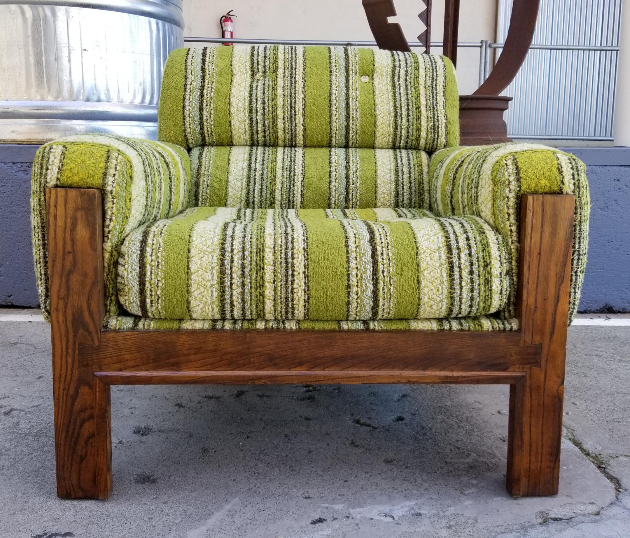 A Mid-Century Modern sofa and lounge chair set, circa 1970s. Amazing original condition! Vintage sets like this are extremely difficult to find in their original state, in this fine condition. Vibrant original green stripped upholstery, solid oak