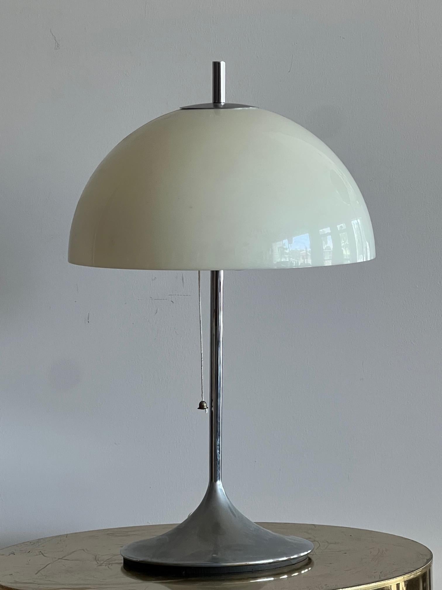 A fun 1970's pop table lamp by Frank Bentler, made in Denmark. White acrylic shade and tapered chrome base. A classic 1970's style.