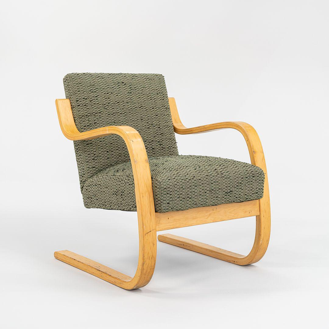 This is an Atelje Lounge Chair, Model 402, designed by Aino and Alvar Aalto for Artek in 1933. This particular example dates to the 1970s. The piece is formed of steam-bent Finnish Birch, and has been newly upholstered in a green nubby fabric. 
 
