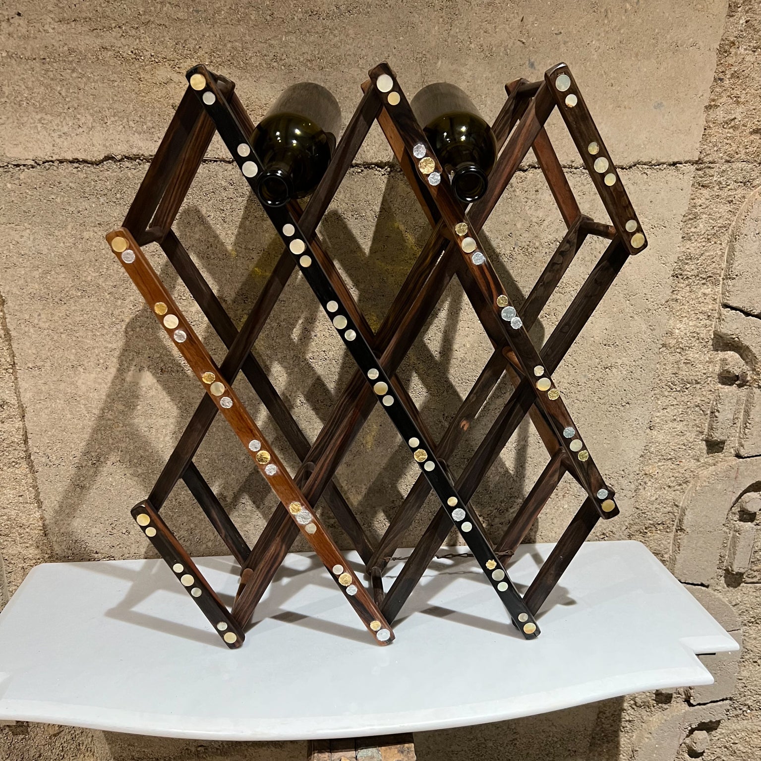 1970s MCM Foldable ten bottle wine rack bottle holder in rosewood and abalone shell
Measures closed 3 x 25 x 6.5 and open 18.5 W x 22.5 x 6.5 D
Preowned original unrestored vintage condition.
See images provided please.