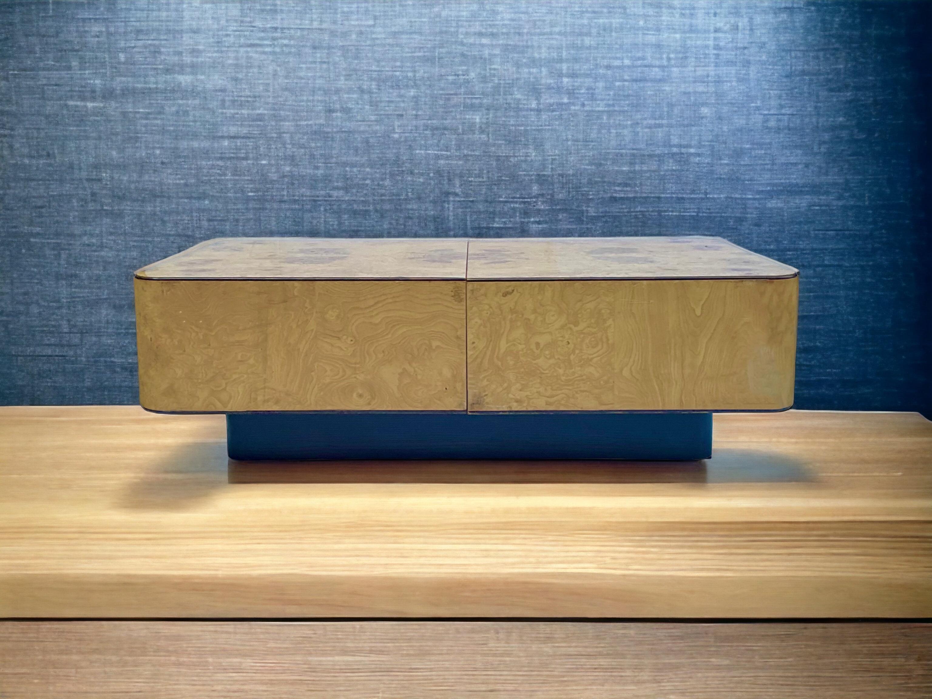 This is a sleek, modern floating burl veneer coffee table in the manner of Milo Baughman. The burl portion slides open easily to reveal storage. The top is on a black rectangular base. It was manufactured by Henredon in the 1970s. It is in very good