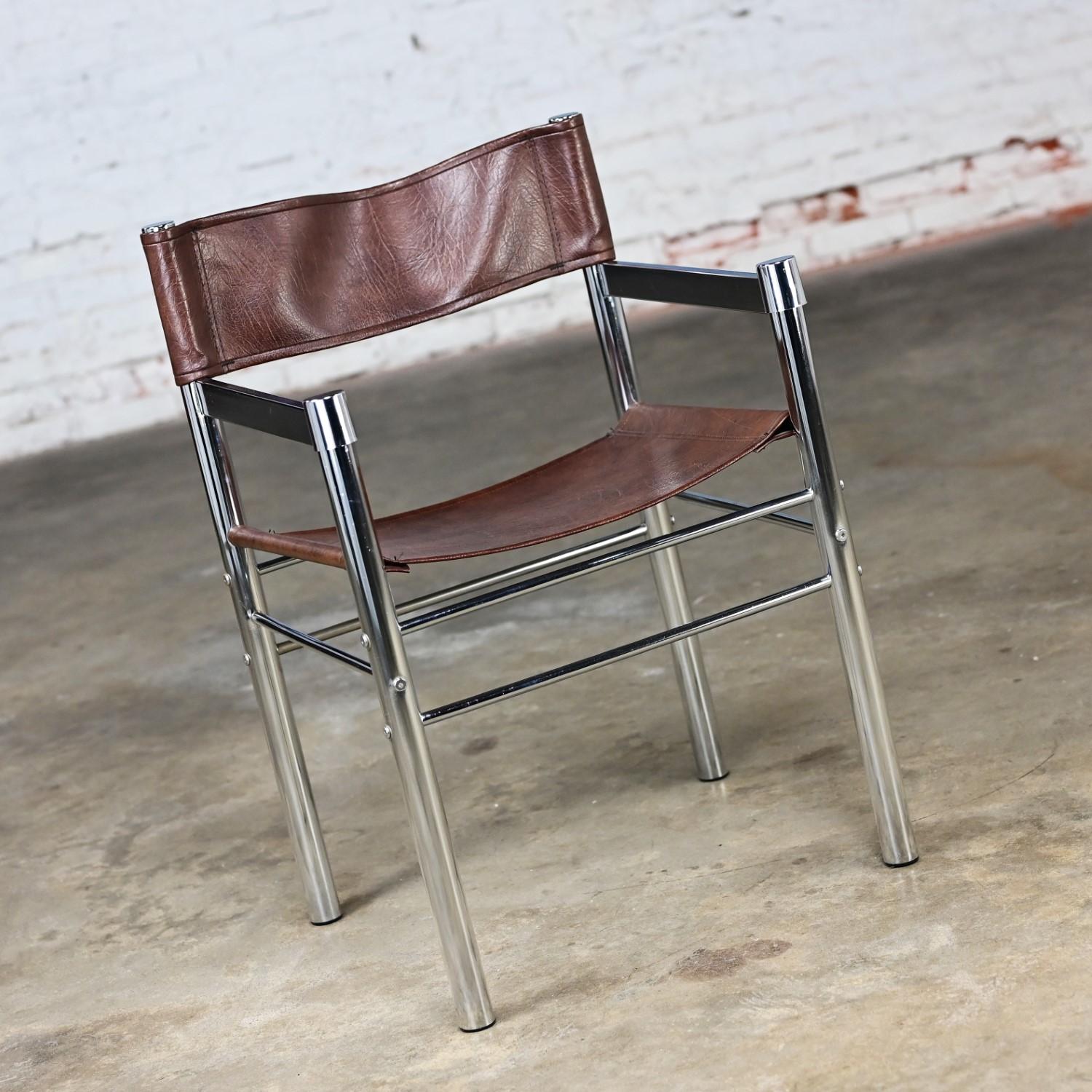 Awesome vintage Modern Director’s or sling chair comprised of a chrome tube frame & brown vinyl or faux leather seat & back sling in the style of James David. Beautiful condition, keeping in mind that this is vintage and not new so will have signs