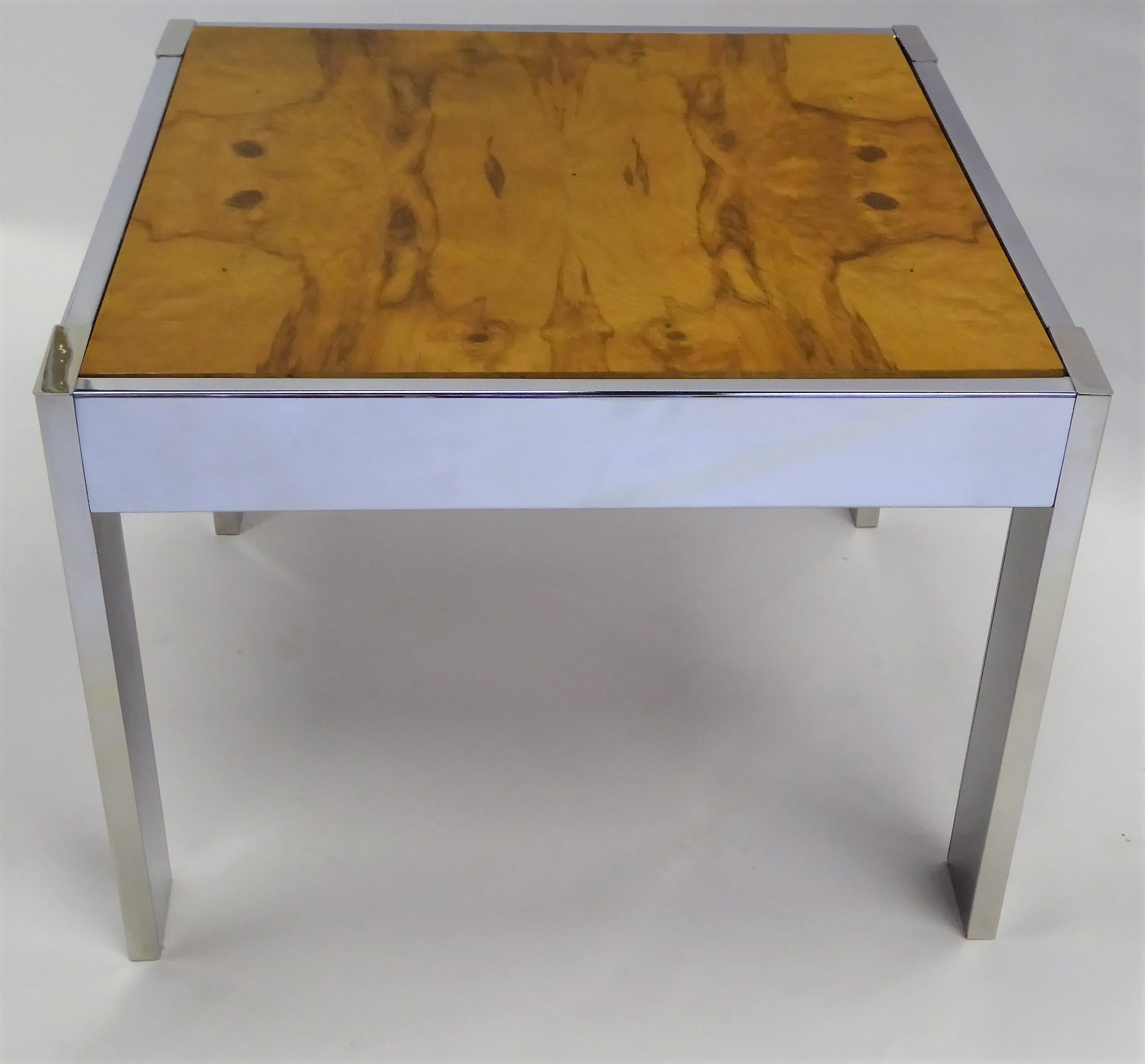 1970s chrome side table with an inset thick bookmatched blond burl veneer top in the style of Milo Baughman. Crafted in Mexico, the top has a clear coat finish and the chrome a mirror polish.
Measurements: 30 1/8 inches x 30 1/4 inches top x 22
