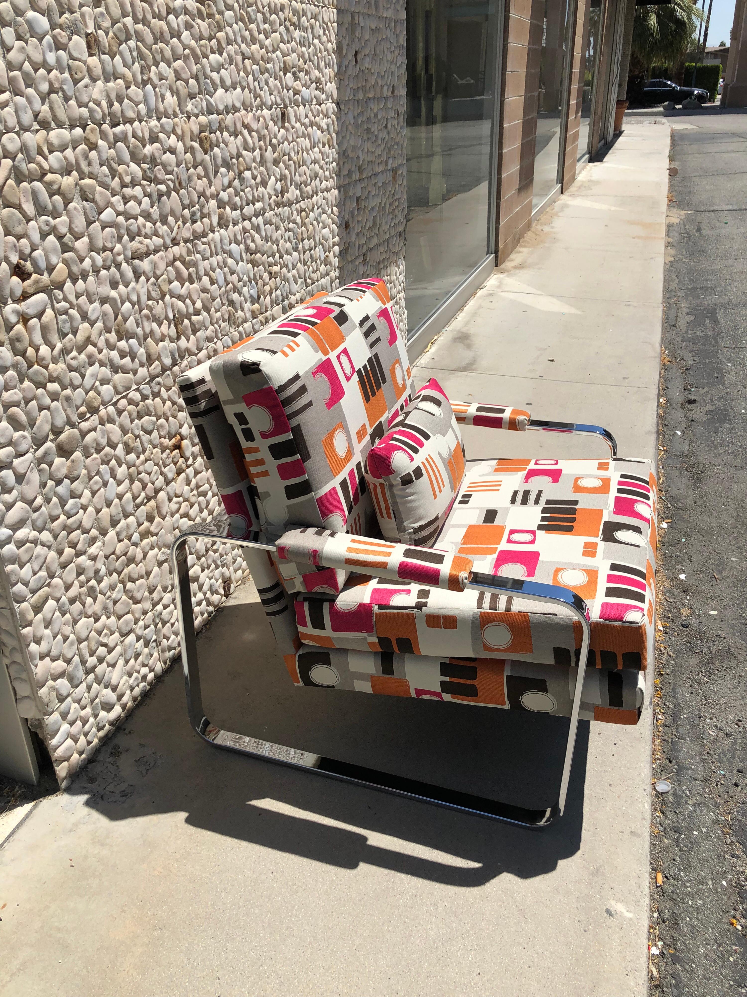 This modern chrome club chair was made in the 1970s. In the style of the iconic Milo Baughman chrome arm chair. The chair has been redone in a very high end modern art jacquard fabric. Including matching kidney back pillow. A beautiful modern art