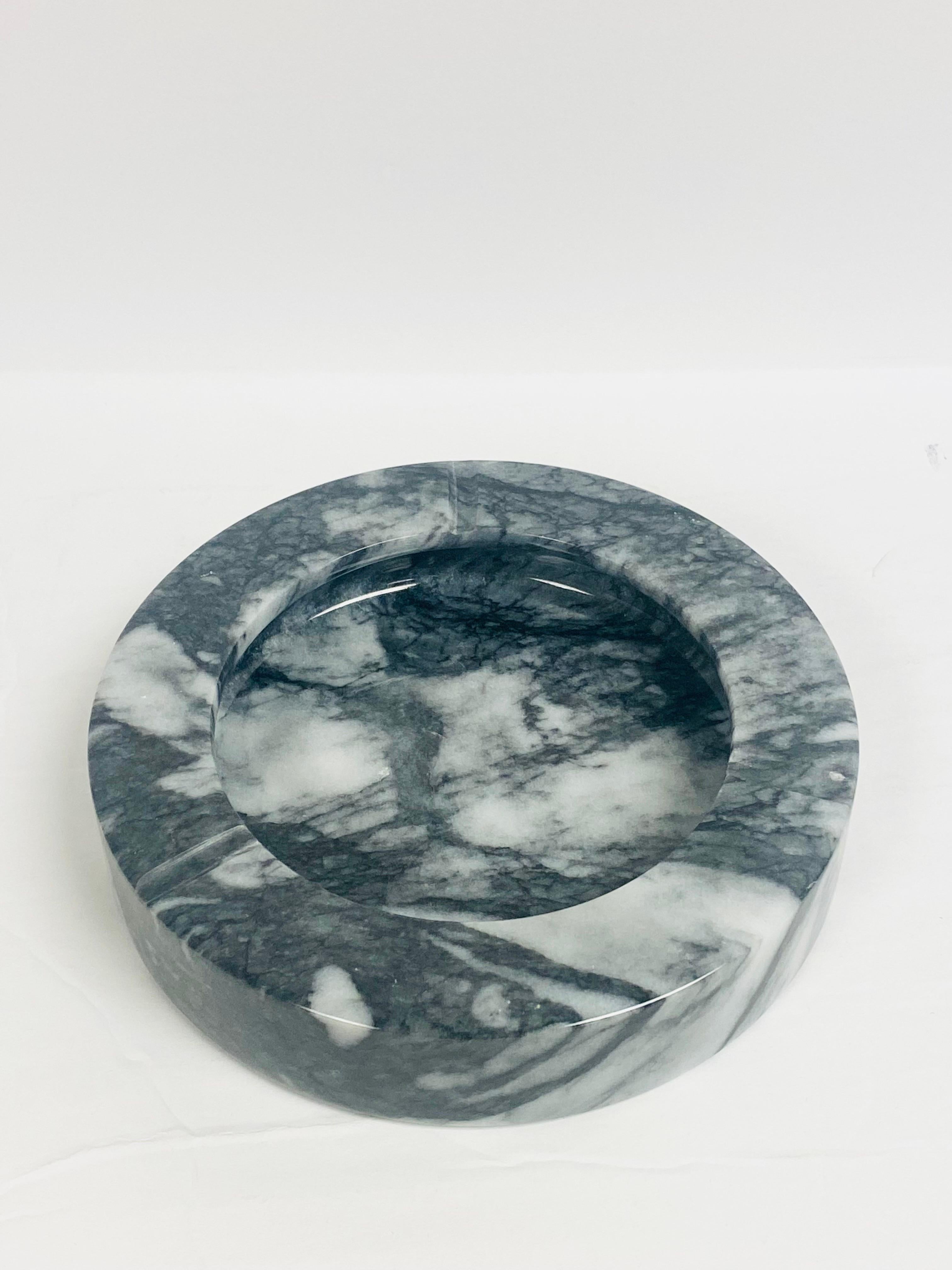 We are very pleased to offer a vintage ashtray, circa the 1970s. Handcrafted from marble by skilled artisans this polished stone ashtray features three cigarette rests. Stunning, dense veins throughout it give it a unique look and lots of movement.
