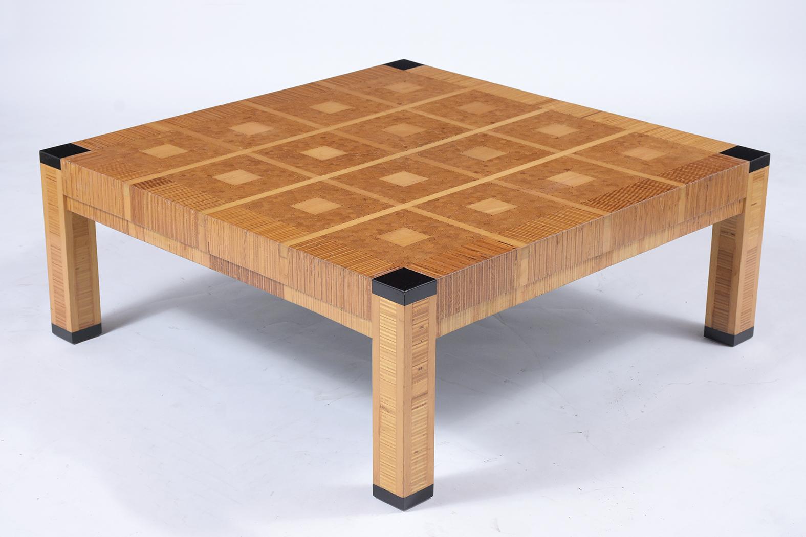 This mid-century modern maple coffee table is made from maple wood that is inlaid in a geometric pattern and has been fully restored by our team of expert craftsmen. The table features a natural finish and ebonized details, and the square pattern is