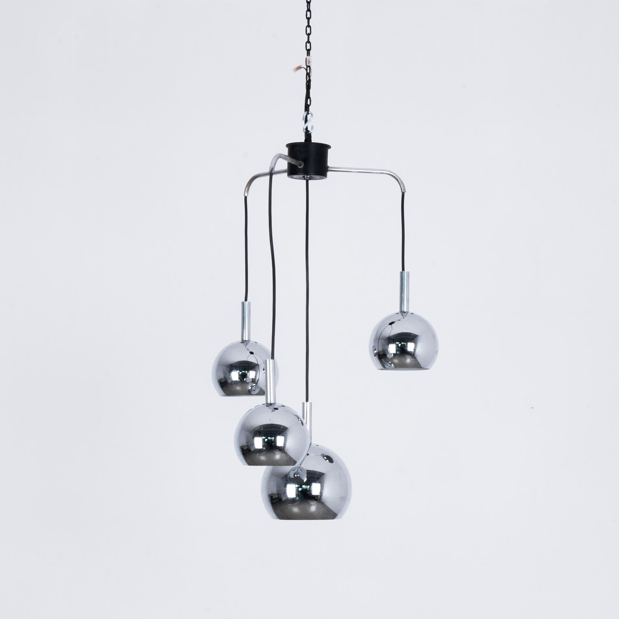 This chandelier from 1970s Italy is composed of four silver pendants, hanging in an asymmetrical formation. The bubble-like forms evoke Space Age chic. The high shine of the reflective metal and a streamlined design give this chandelier a stylish,