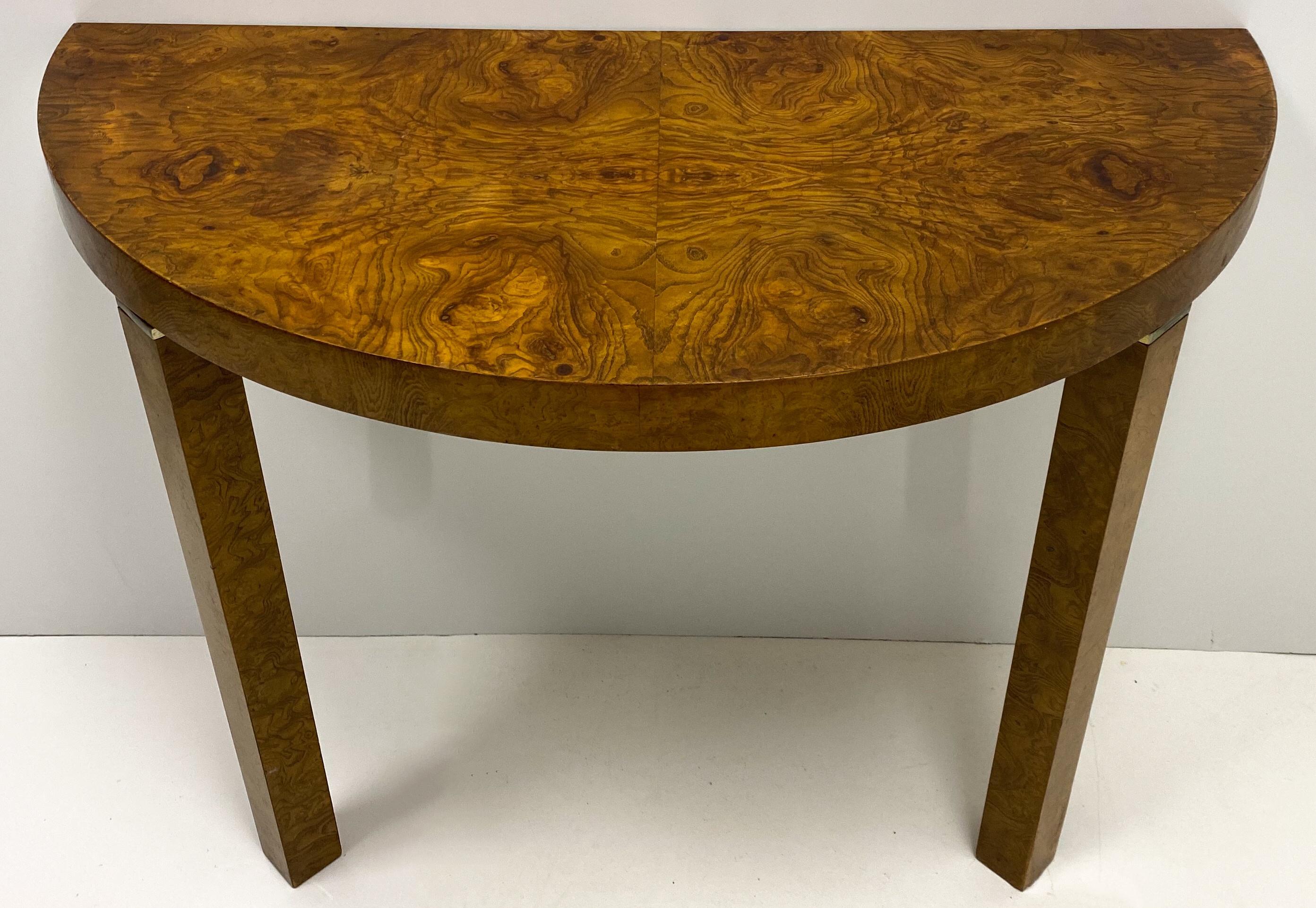 This is a pair of 1970s modern Milo Baughman style burl console tables. The top of each leg has a brass CAP They are wall-mounted. They tables are not marked, but they are in very good condition.