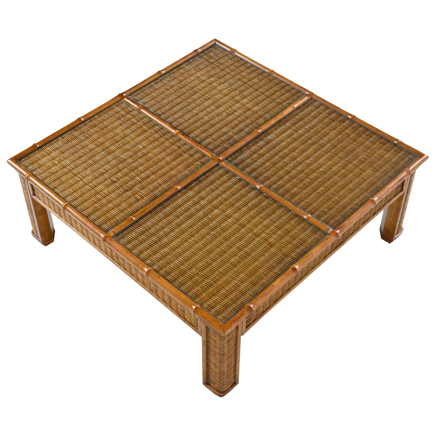 Vintage 1970s monumental boho wicker and rattan coffee table. Four in-set glass panels add a touch of elegance and enhance functionality. Constructed of wicker with four in-set glass panels and trimmed in robust rattan. The table is at once Bohemian
