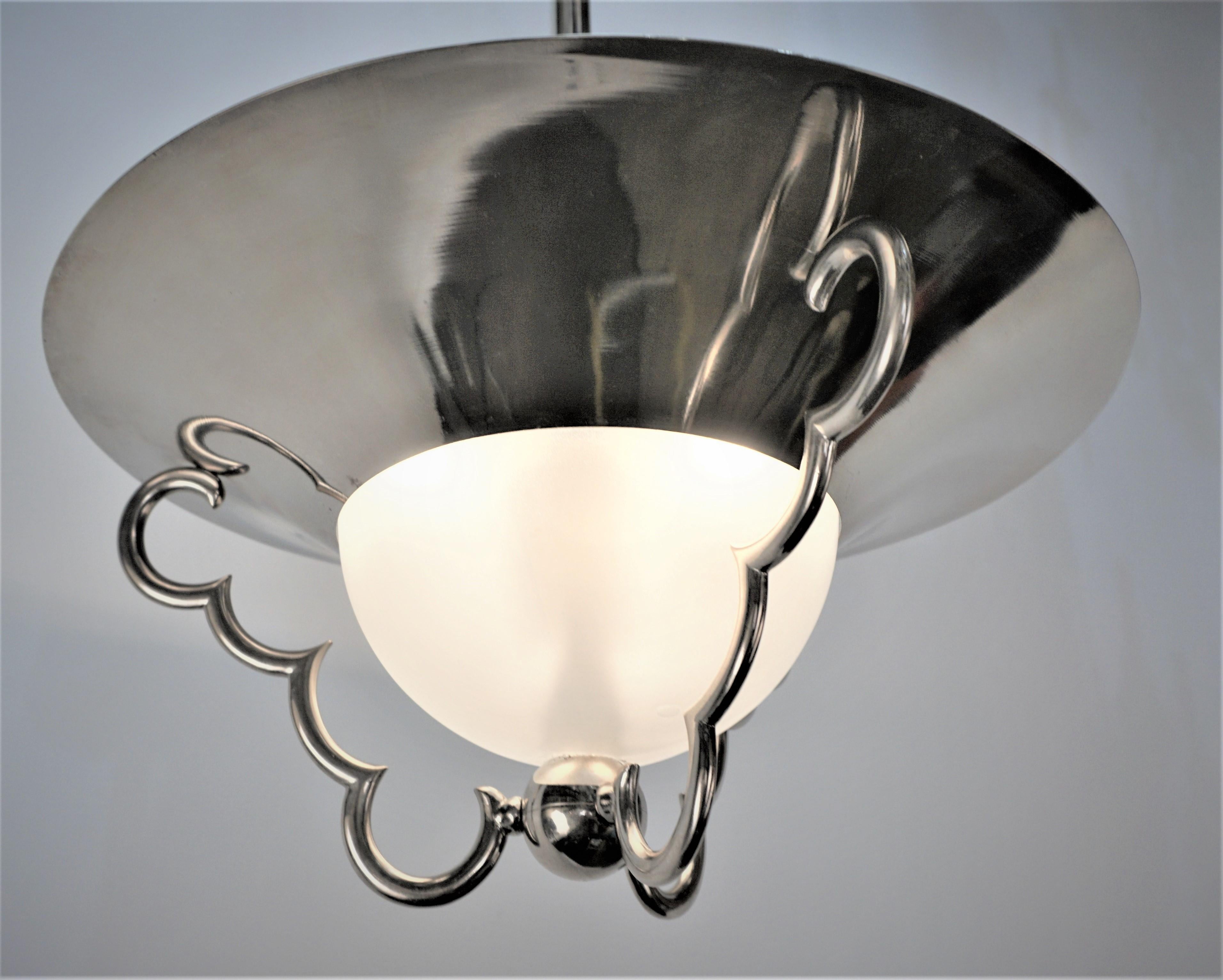1970's Modern three light nickel frame with clear frost center glass chandelier.
75 watts max each light.