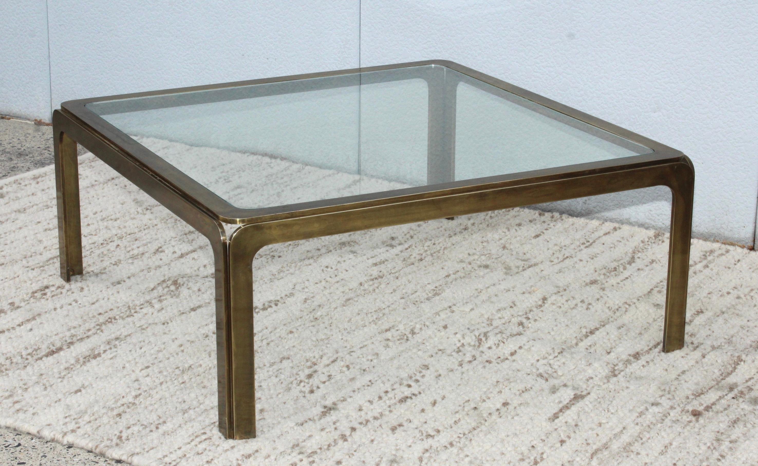 1970s patinated brass with glass top square coffee table from Spain.