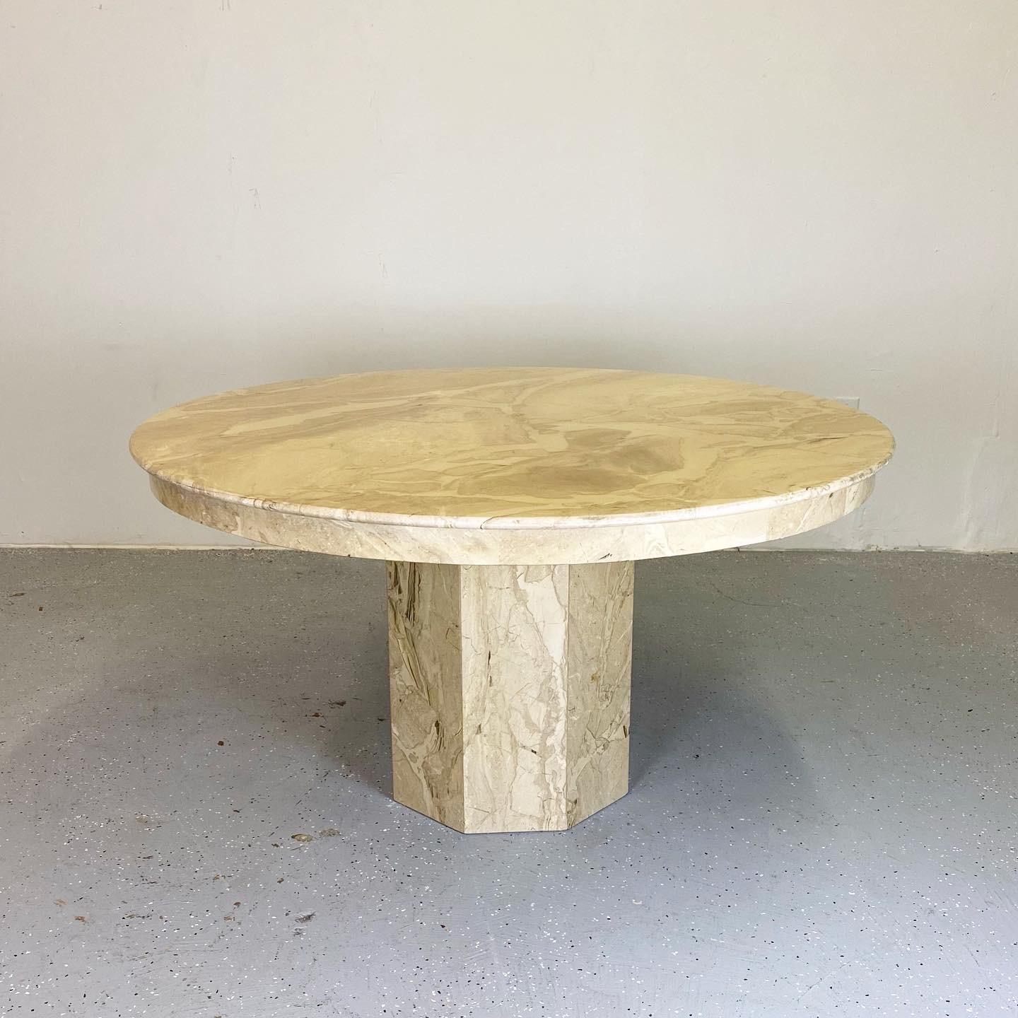 Beautiful vintage dining table with striking marble top. This piece has a minimal design with a warm inviting tone.