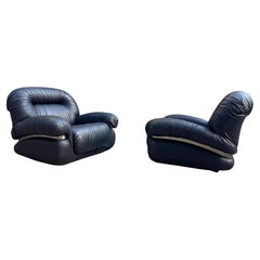 1970s modern sculptural set of black leather armchairs, stainless steel frame