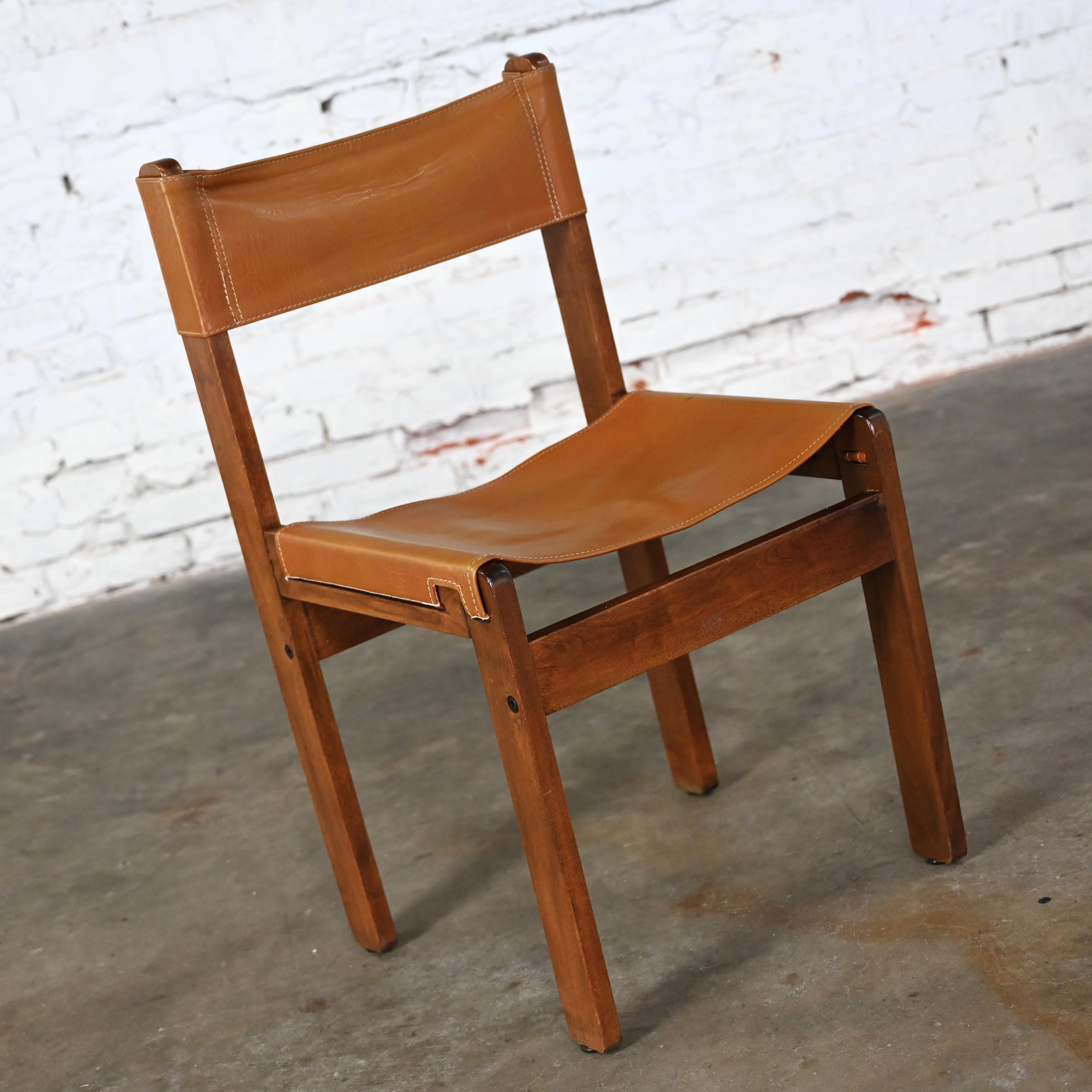 Wonderful vintage Modern side sling chair comprised of teak & cognac leather in the style of Michel Arnoult and made in Argentina. Beautiful condition, keeping in mind that this is vintage and not new so will have signs of use and wear. Please see