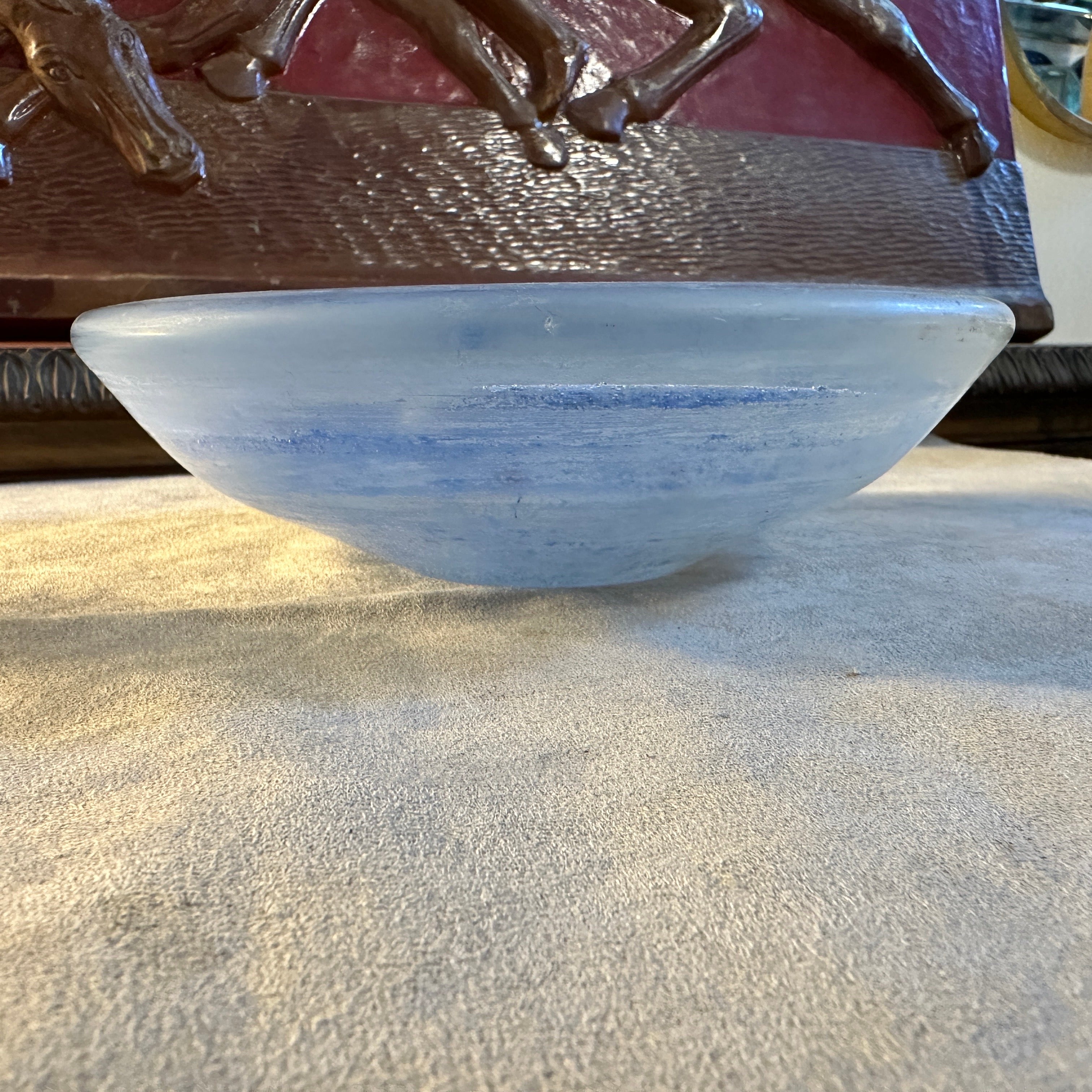 A perfect condition blue murano glass round bowl designed and manufactured in Venice in the Seventies. Crafted in the renowned Murano glassmaking tradition, this bowl is a testament to the skill and creativity of its makers. The vibrant blue hue of