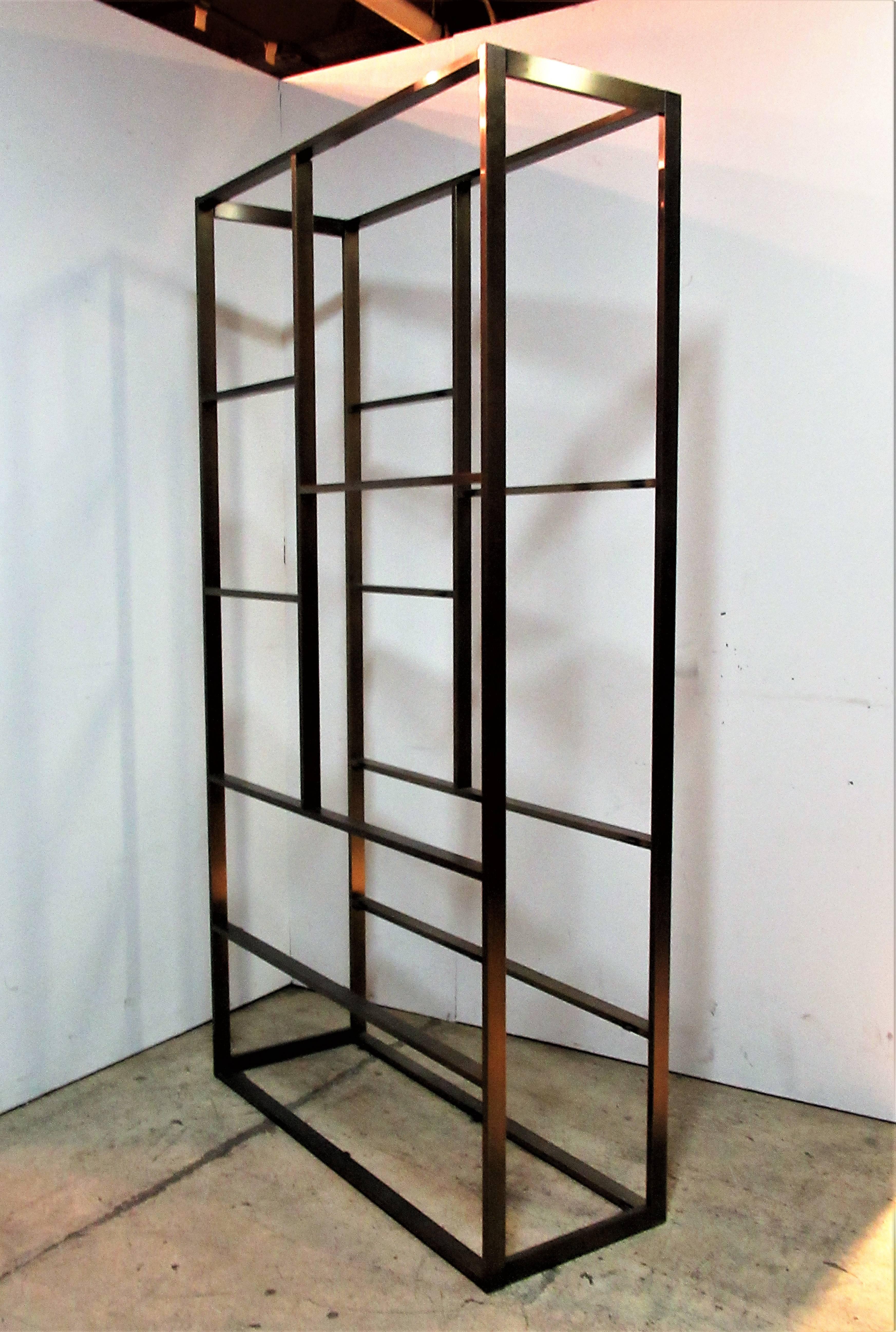 Exceptionally fine quality heavyweight bronzed steel etagere with seven glass shelves - circa 1970 designed by Milo Baughman. Structurally perfect solid strong. Great condition. Beautiful