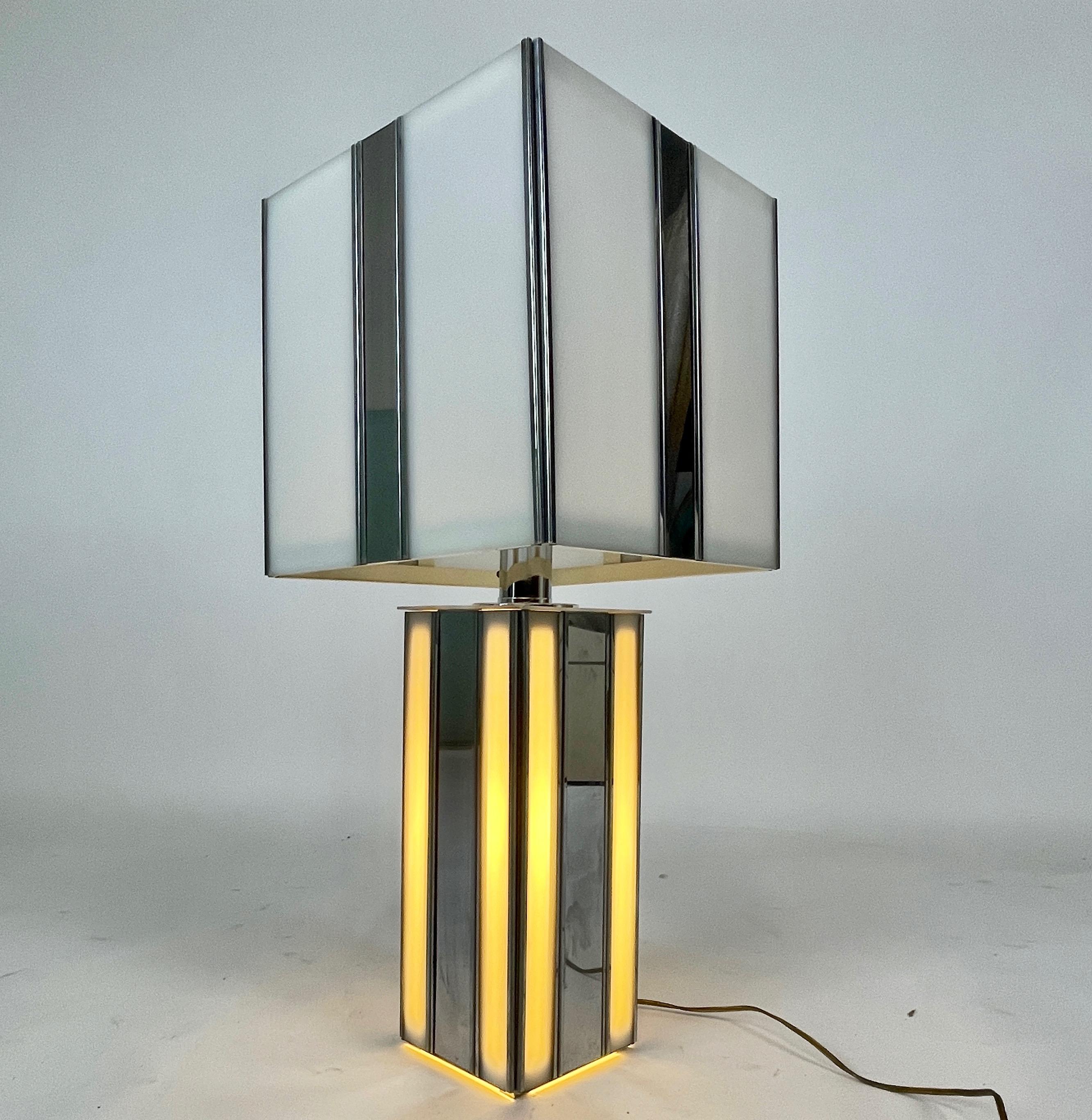 Incredible 1970s lamp made of chrome and plexiglass with a two way switch for lamp and illuminating base. The shade consists of chrome strips and alternating lucite panels .Lamp has a very chic look.
Plexi is white - The First photo shows a