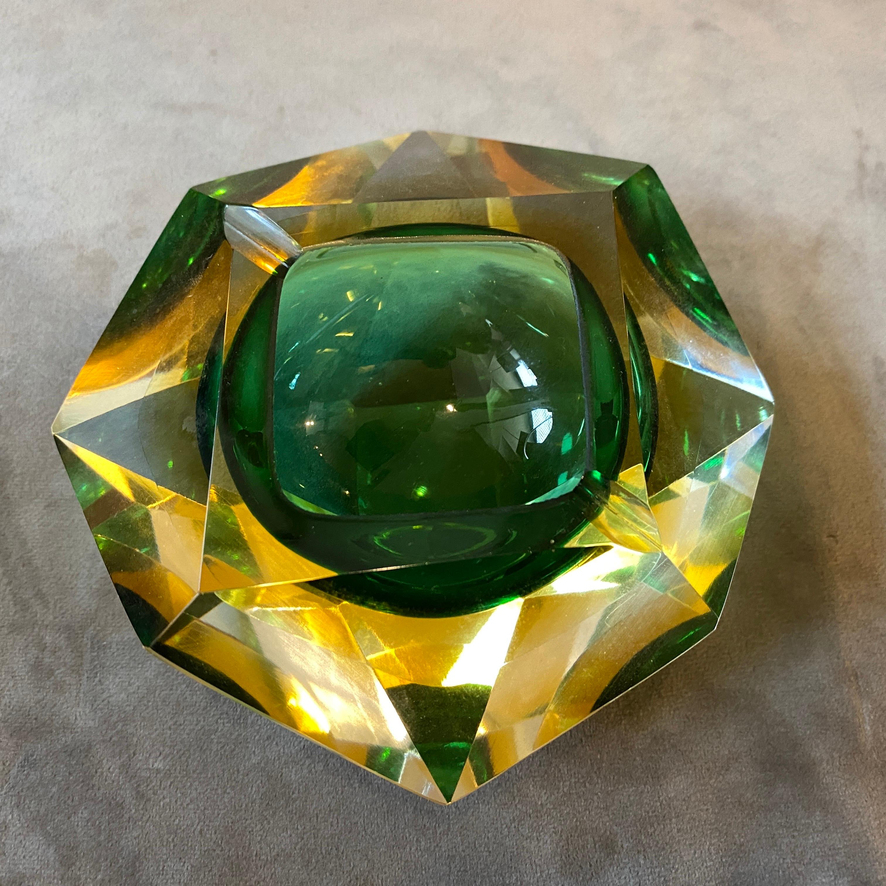 An iconic yellow and green sommerso murano glass ashtray designed and manufactured in the Seventies by Seguso, it's in perfect conditions.
The Ashtray by Seguso is a striking piece of glassware, it features a modernist design characterized by facets