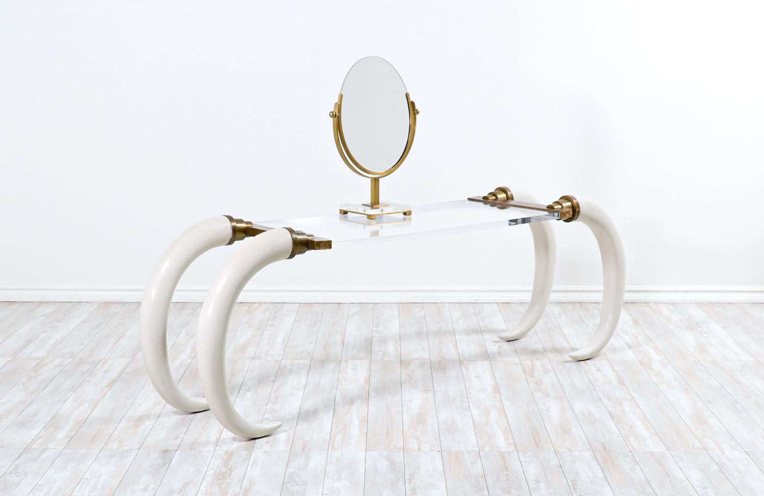 1970s modernist faux elephant tusk brass & lucite console table.

________________________________________

Transforming a piece of Mid-Century Modern furniture is like bringing history back to life, and we take this journey with passion and