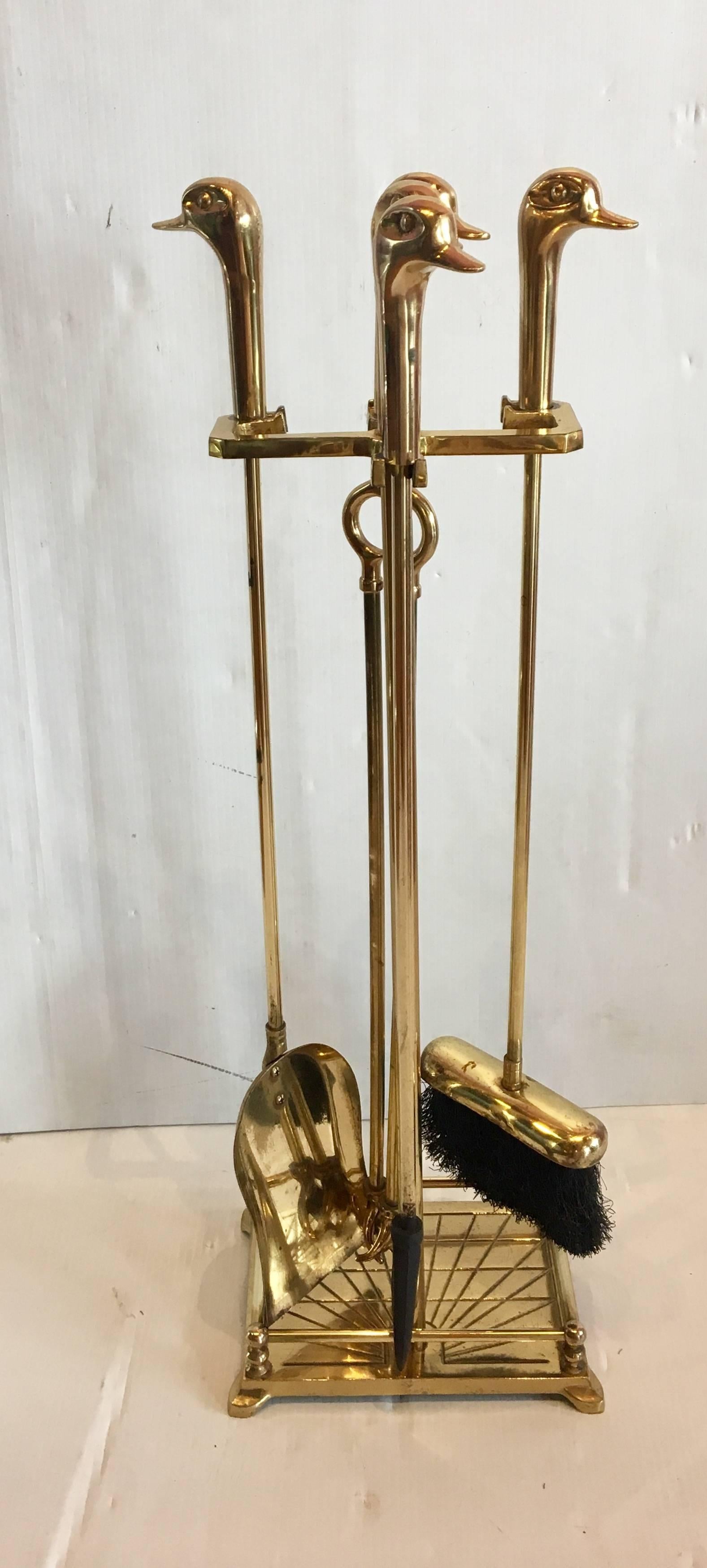Elegant polished Italian solid brass fireplace tools set. With ducks heads handles.