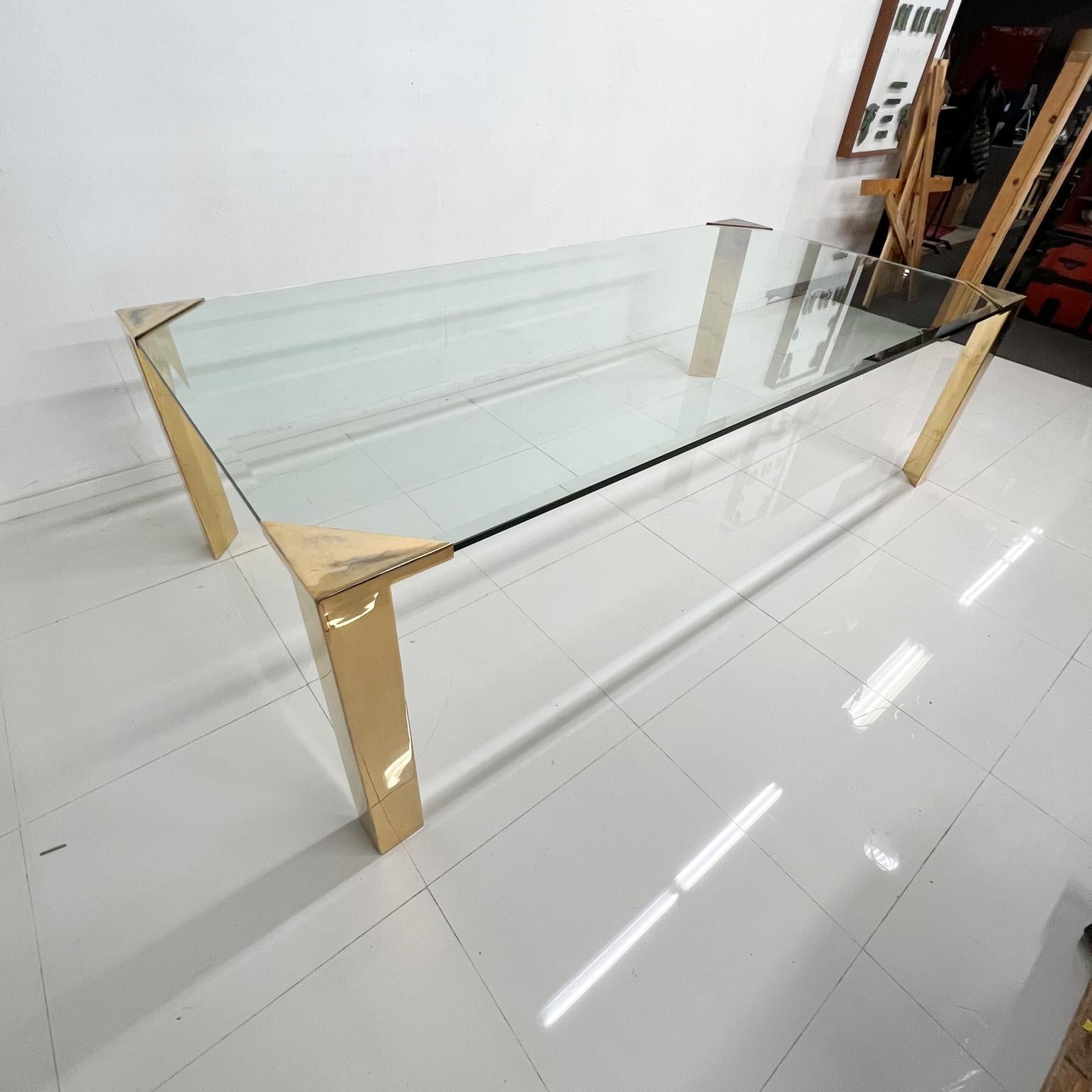 
1970s Modern Elegance Long Dining Table attribution Pace Collection.
In the style of Romeo Rega and Mastercraft. 
Stunning Regency 
Unmarked, no label.
Brass plated legs. 
New .75 thick glass with beveled edges 
Unrestored original patina, vintage