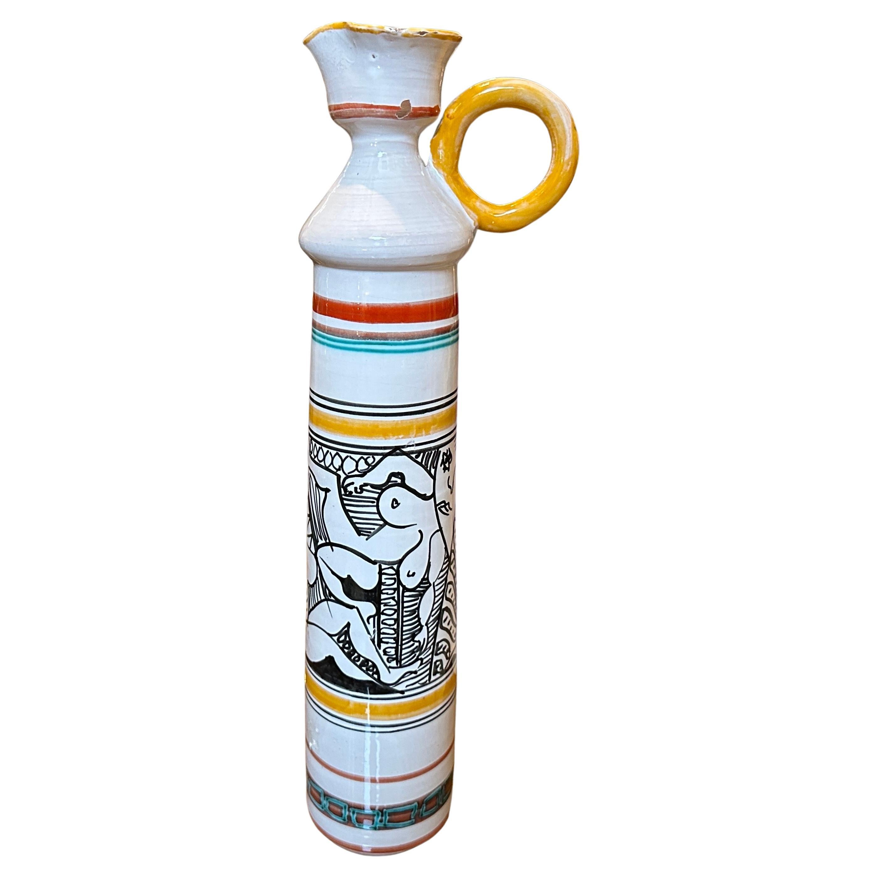 This jug is a beautiful example of Modernist design fused with traditional Sicilian artistic elements, showcasing bold colors, intricate patterns, and a focus on hand-made quality. Its unique aesthetic makes it a standout decorative piece from the