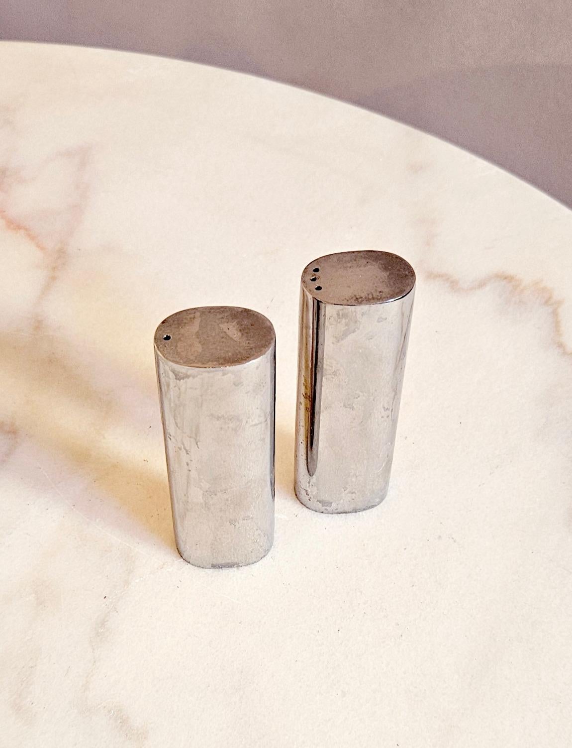 A simple pair of silver coloured metal salt and pepper pots found in Italy.