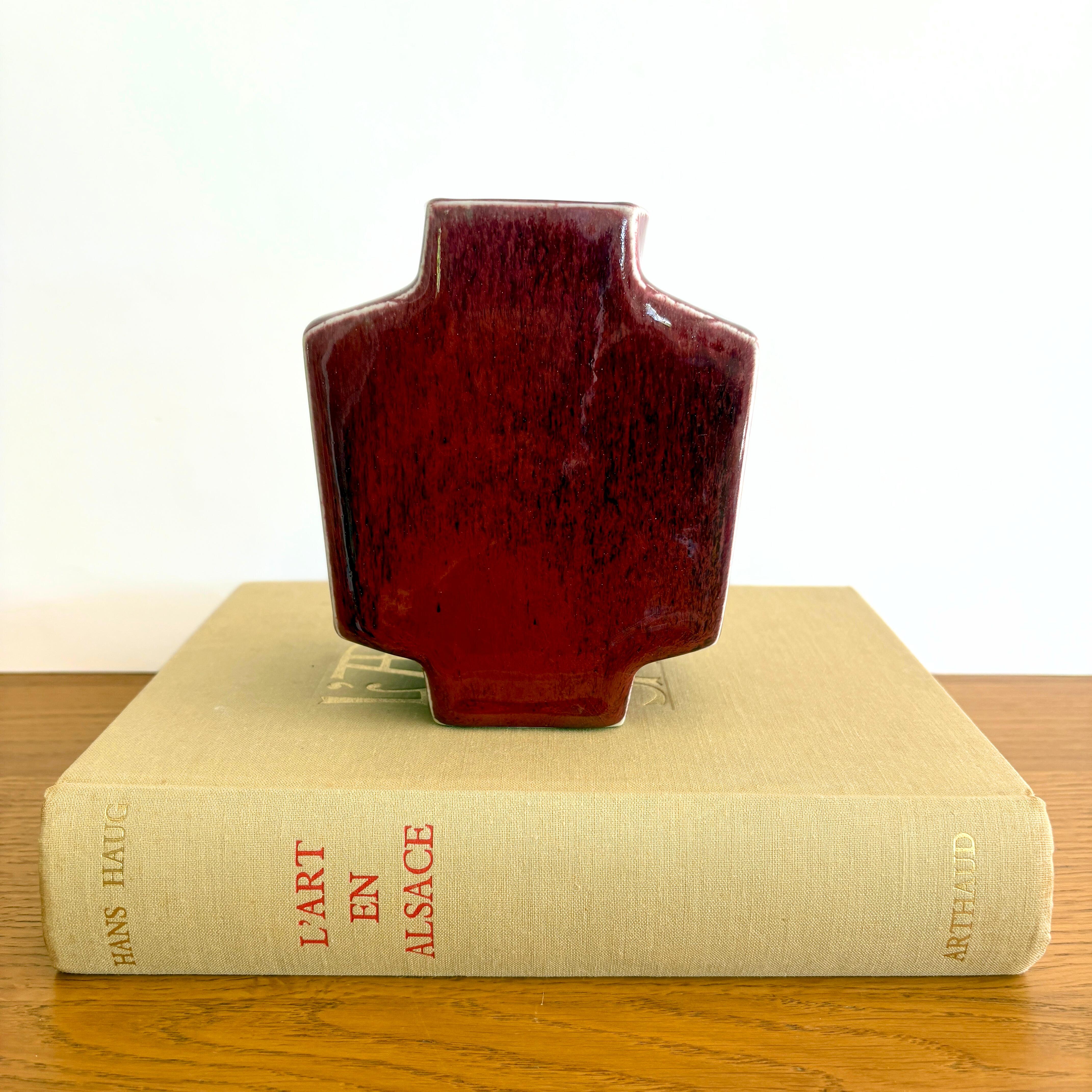 A striking and recognizable design piece from the 1970s by renowned artist couple, Jacqueline and Tim Orr. This porcelain vase was made in their studio in Biot, France. This mid-century modern inspired model was made in several different colors.