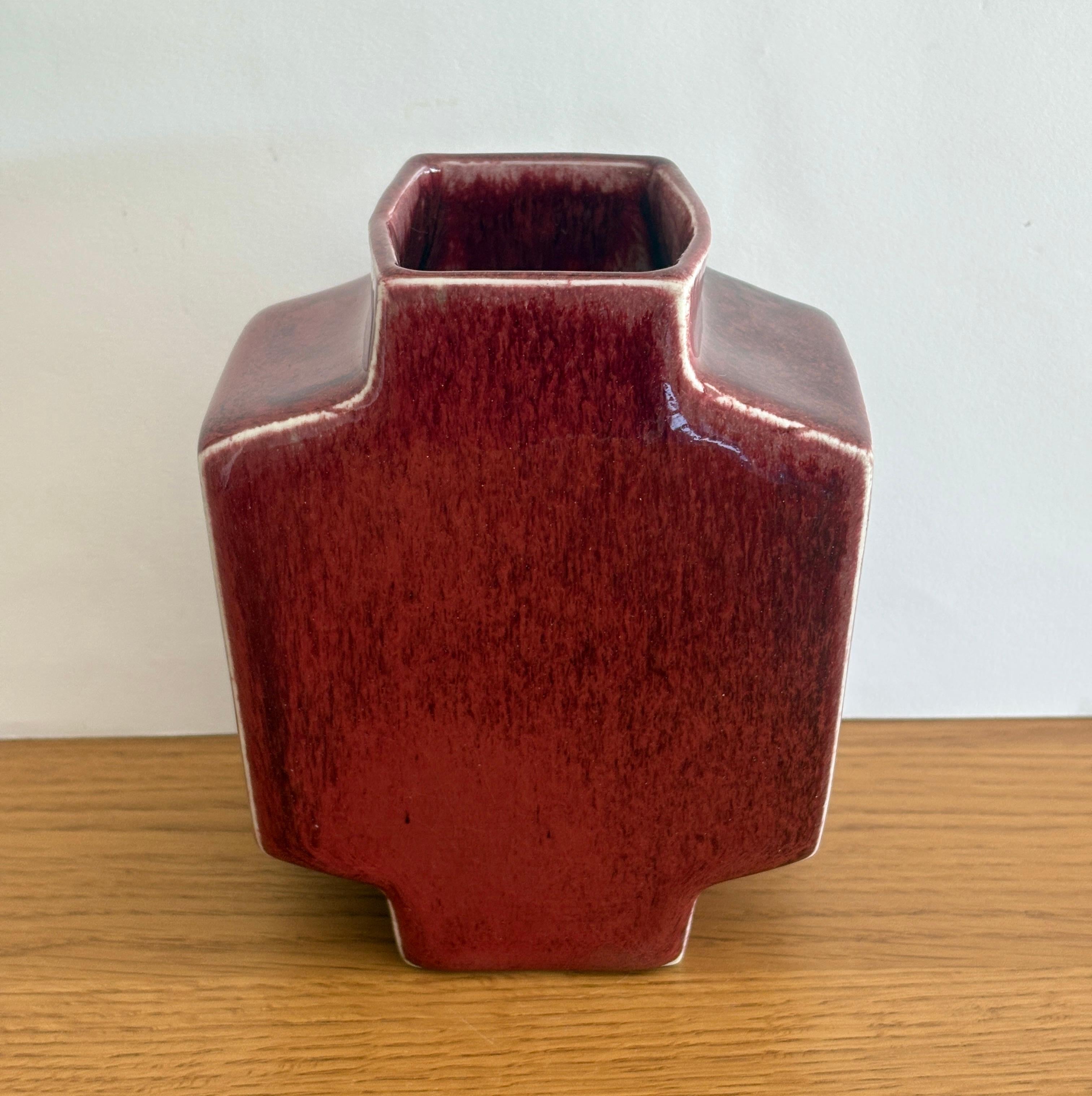 A striking and recognizable design piece from the 1970s by renowned artist couple, Jacqueline and Tim Orr. This porcelain vase was made in their studio in Biot, France. This mid-century modern inspired model was made in several different colors.