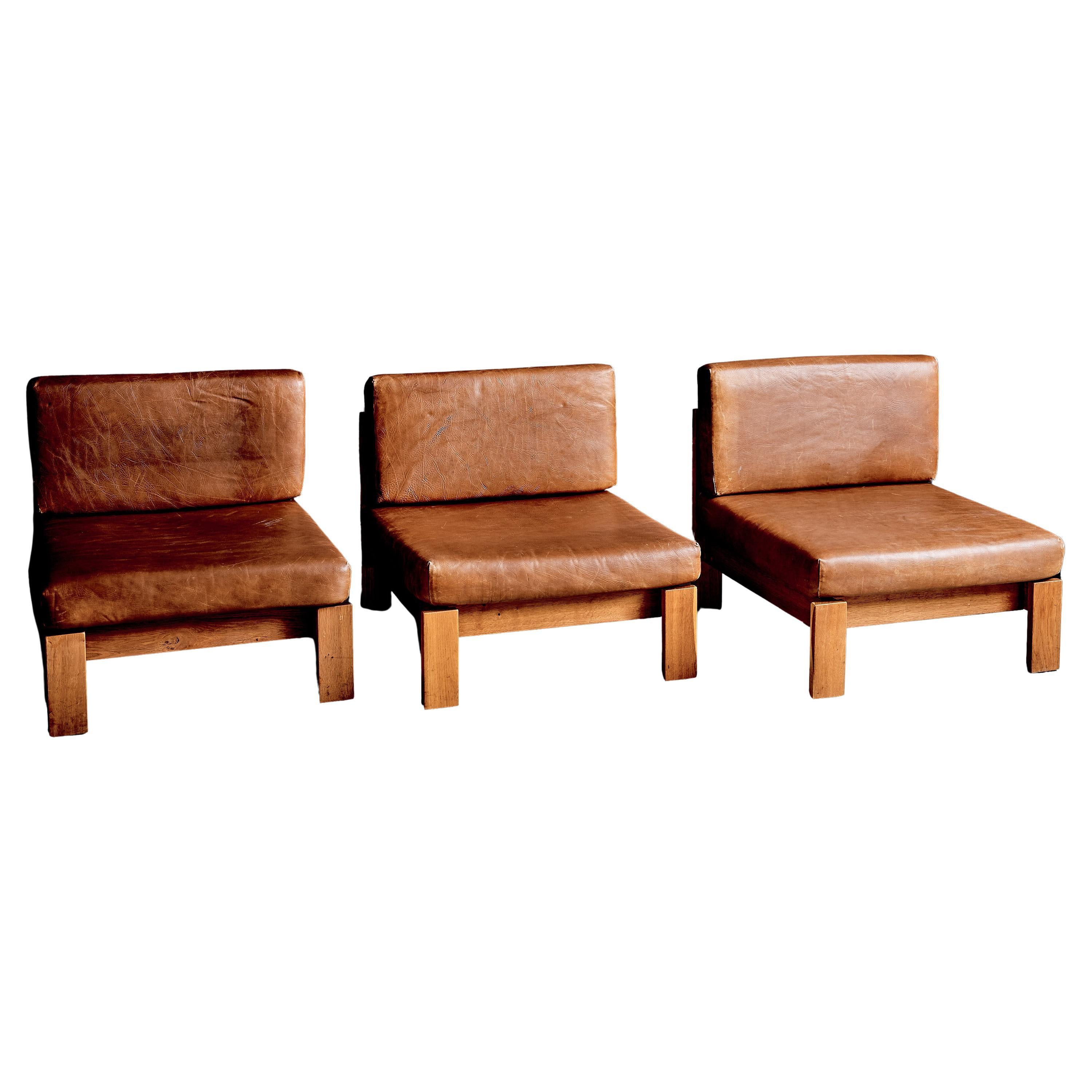 1970s Modular seating group of three lounge chairs in oak and leather, Germany For Sale