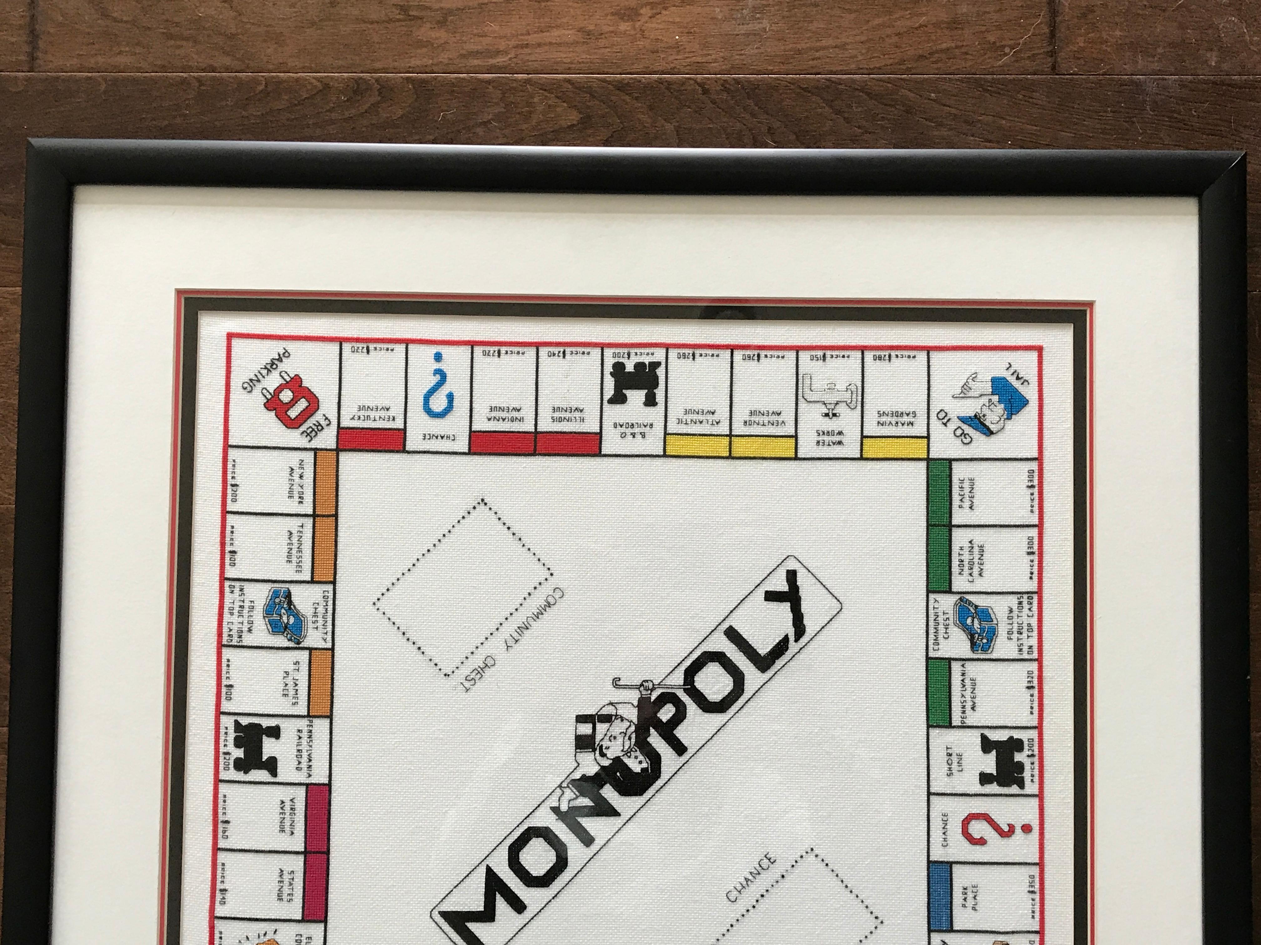 Offered is a stunning, 1970s framed needlepoint of a Classic 'Monopoly' board. Newly framed and matted -- wood frame with a matte finish black lacquer. The piece has been finished with a primarily white mat with black and red accenting mats. Actual