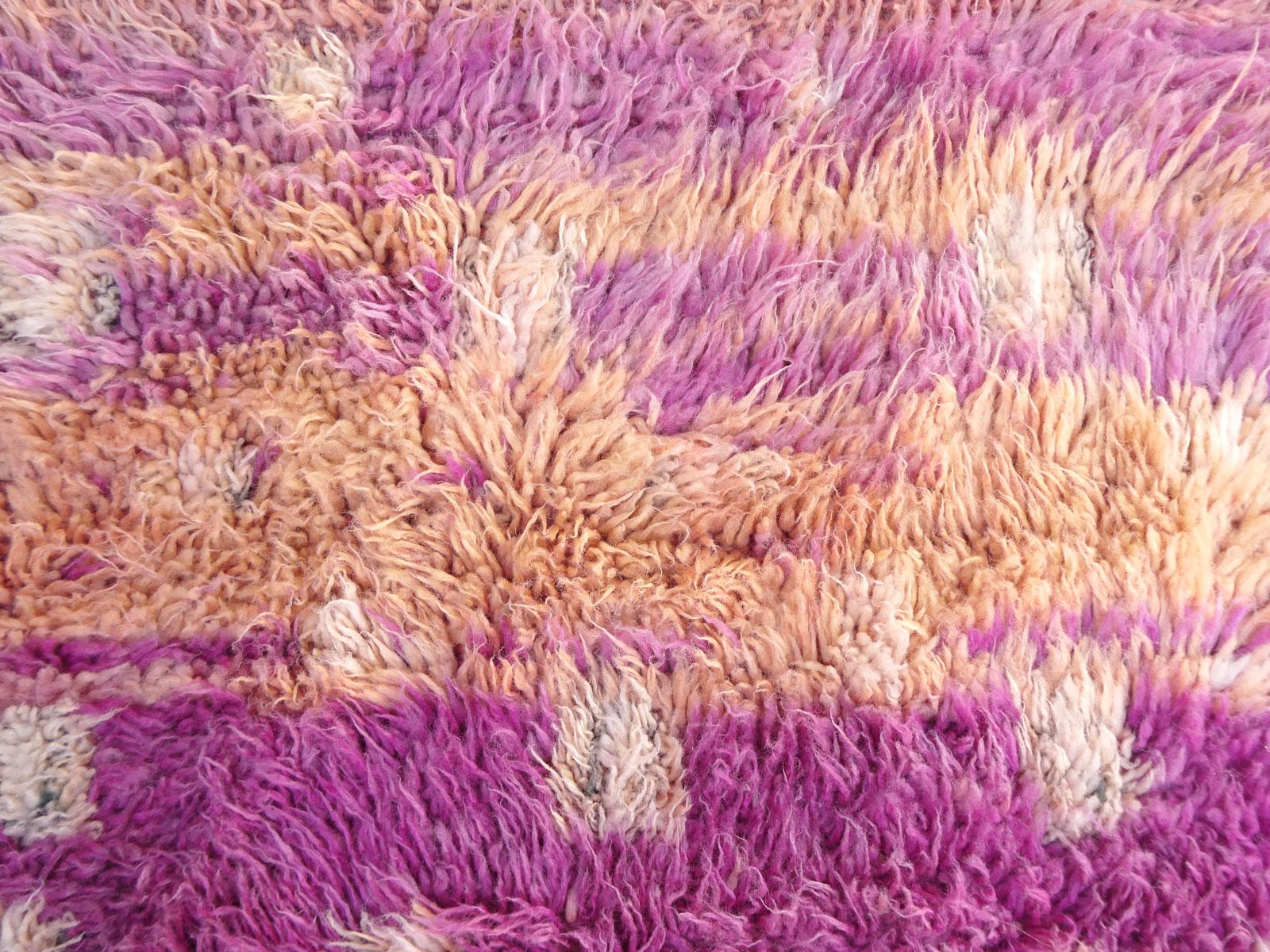 1970s Moroccan Oulmes rug handwoven with shades of framboise and blush high pile wool in an abstract Berber design. 
The Oulmes rugs come from the Zemmour tribe, inhabiting the beautiful area of the Middle Atlas. They produce unique rugs that blend