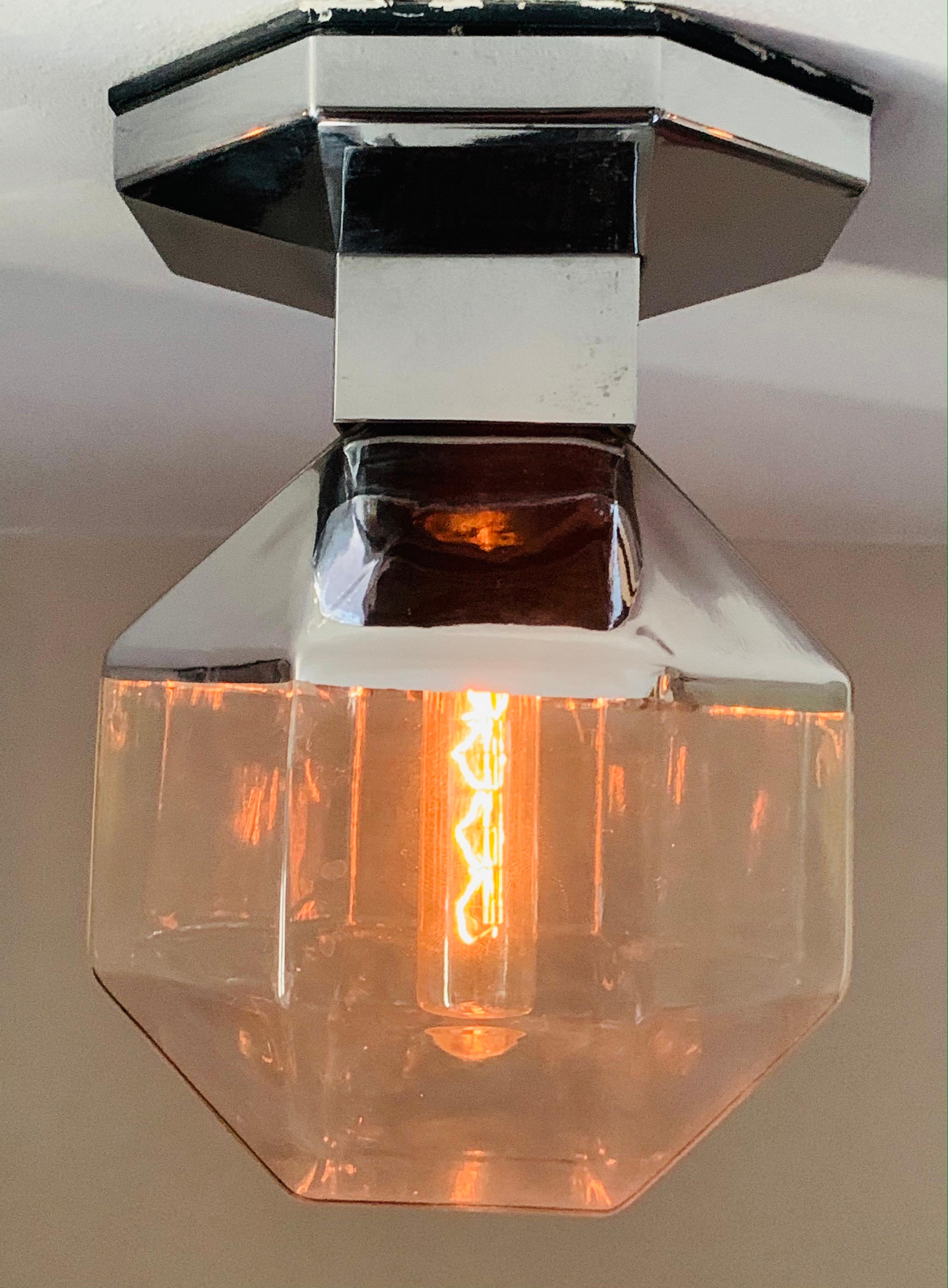 I have also listed this wall light as a table lamp because I think it works well as both.  Designed by Motoko Ishii for Staff Leuchten during the 1970s in Germany. The hexagonal clear glass shade is coated silver on the bottom half and clips into a