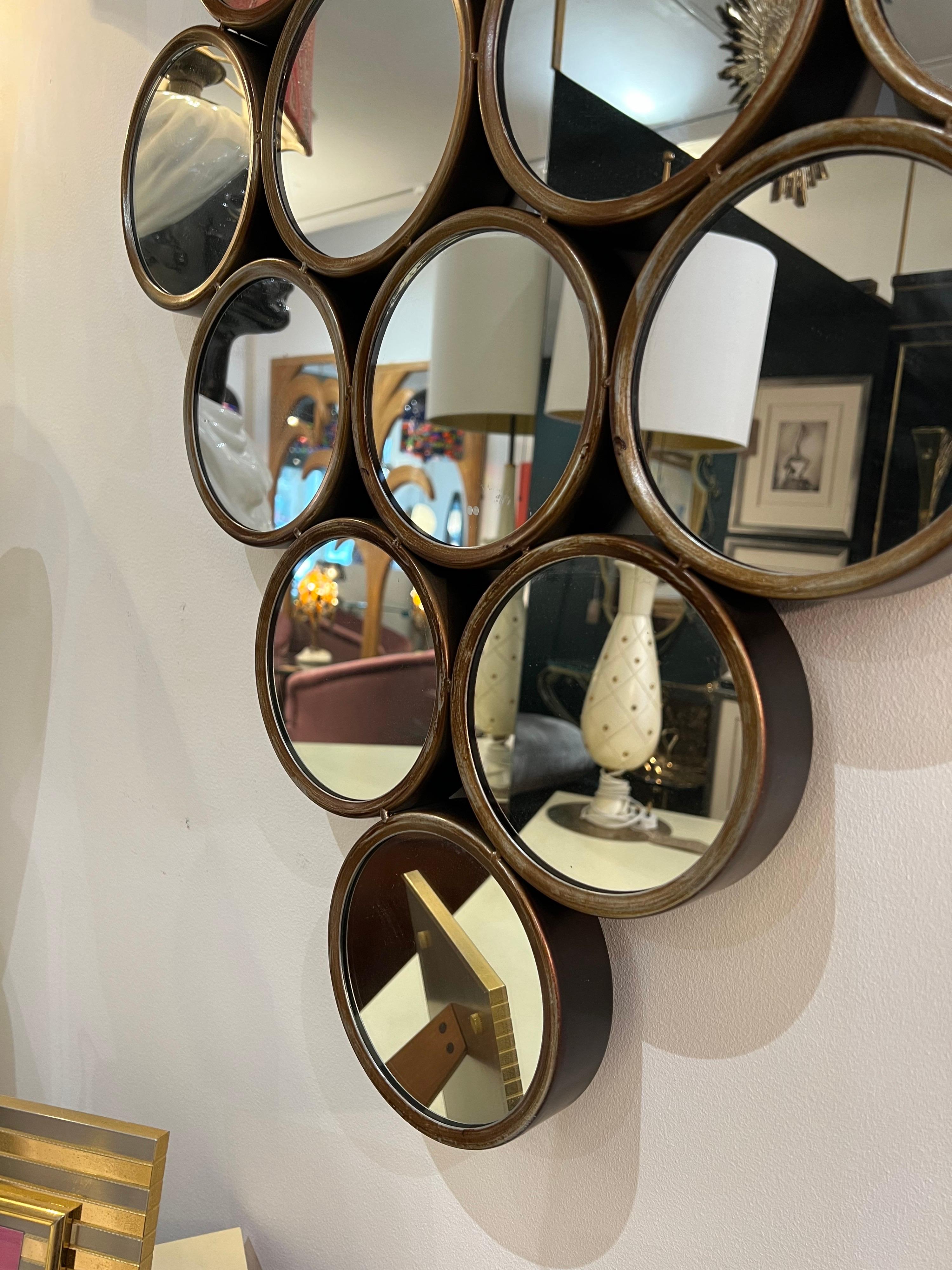 A lovely decorative design multi circle wall mirror with 16 rounded metal frames in antiqued brass that can be hanged vertically or horizontally 95cm x 62cm x 4cm.