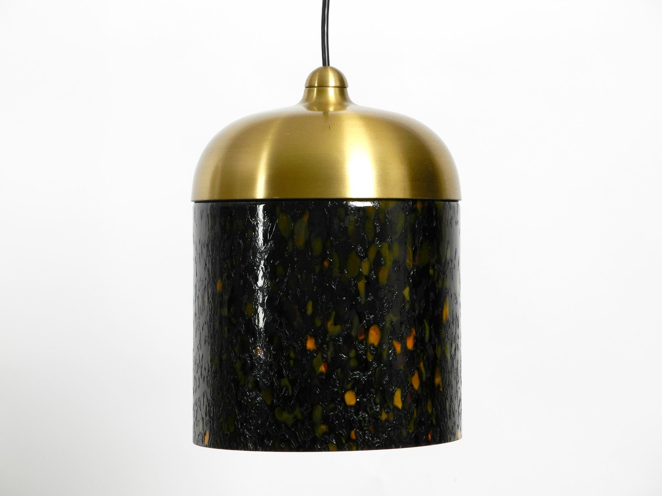 1970s multicolored coated Putzler glass pendant lamp.
Very nice minimalistic space age pop art design with very pleasant light 
created through the thick colored glass.
Glass cover is made of gold-colored metal and with original canopy.
No