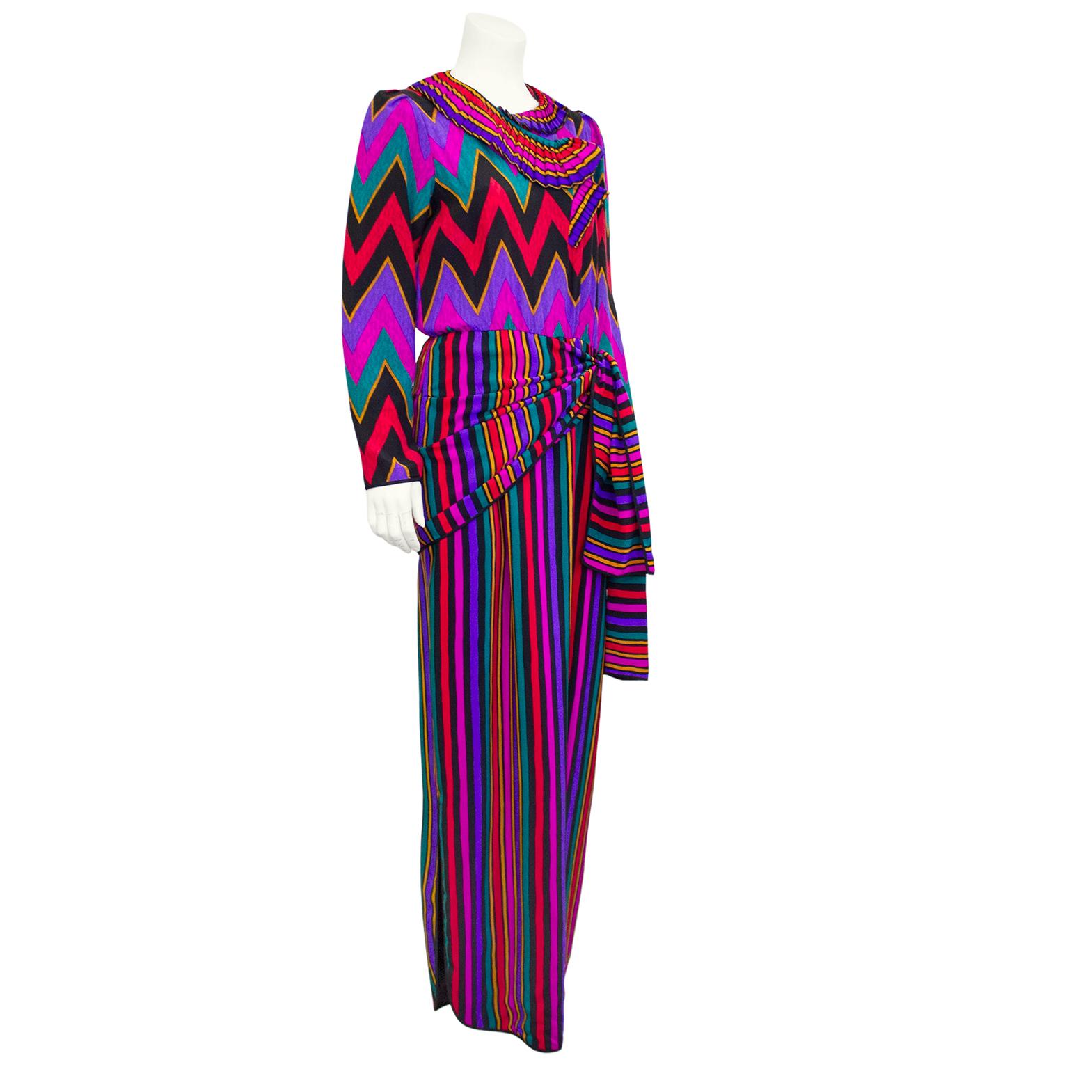 Stunning vibrant 1970's French printed silk dress with pleated collar, long sleeves and a wrap feature at the waist. Although it sounds like a lot, all the elements work so well together on this elegant day/dinner dress. Pair with black boots and a