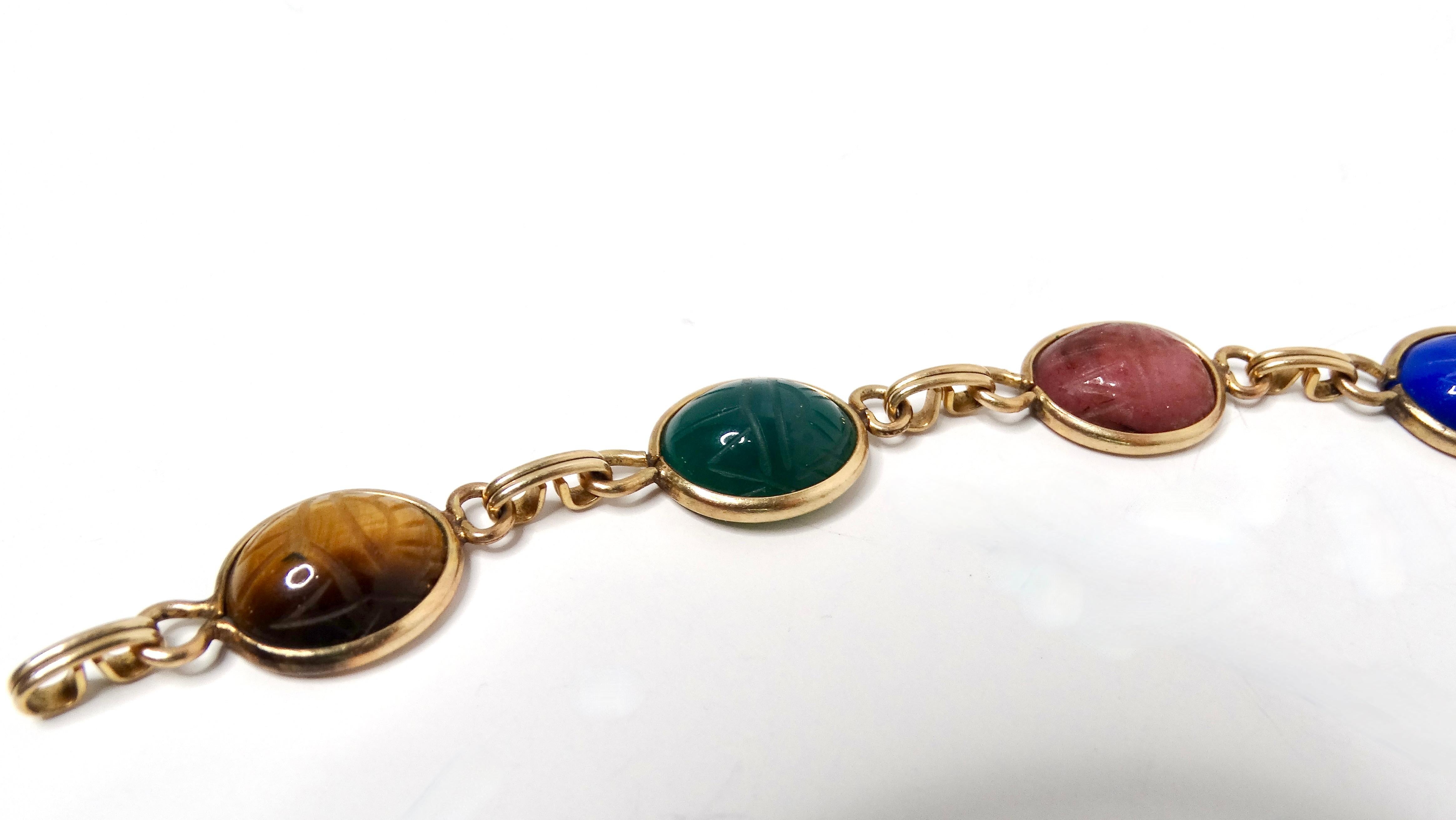 The 1970s multicolor gemstone scarab beetle carved gold-tone bracelet is a stunning embodiment of vintage artistry and bold design. Featuring intricately carved scarab beetles in vibrant hues, this bracelet adds a captivating touch to any ensemble.