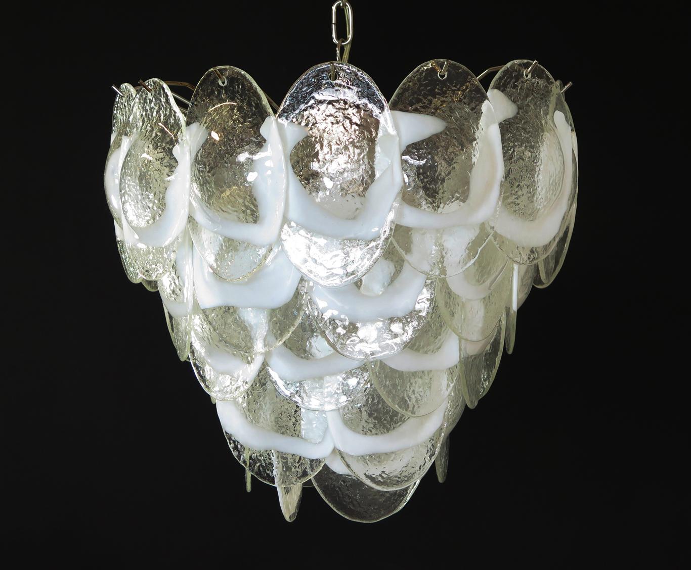 Italian vintage Murano chandelier made by 41 glass leaves in a chrome frame. The originality of this chandelier is given by the glass, wonderful works of art trasparent and lattimo, called shells. Murano blown glass in a traditional way.
Period: