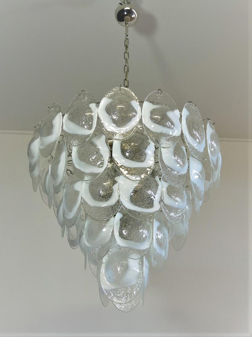 Italian vintage Murano chandelier made by 51 glass leaves in a chrome frame. The originality of this chandelier is given by the glass, wonderful works of art transparent and lattimo, called shells. Murano blown glass in a traditional way.
Period:
