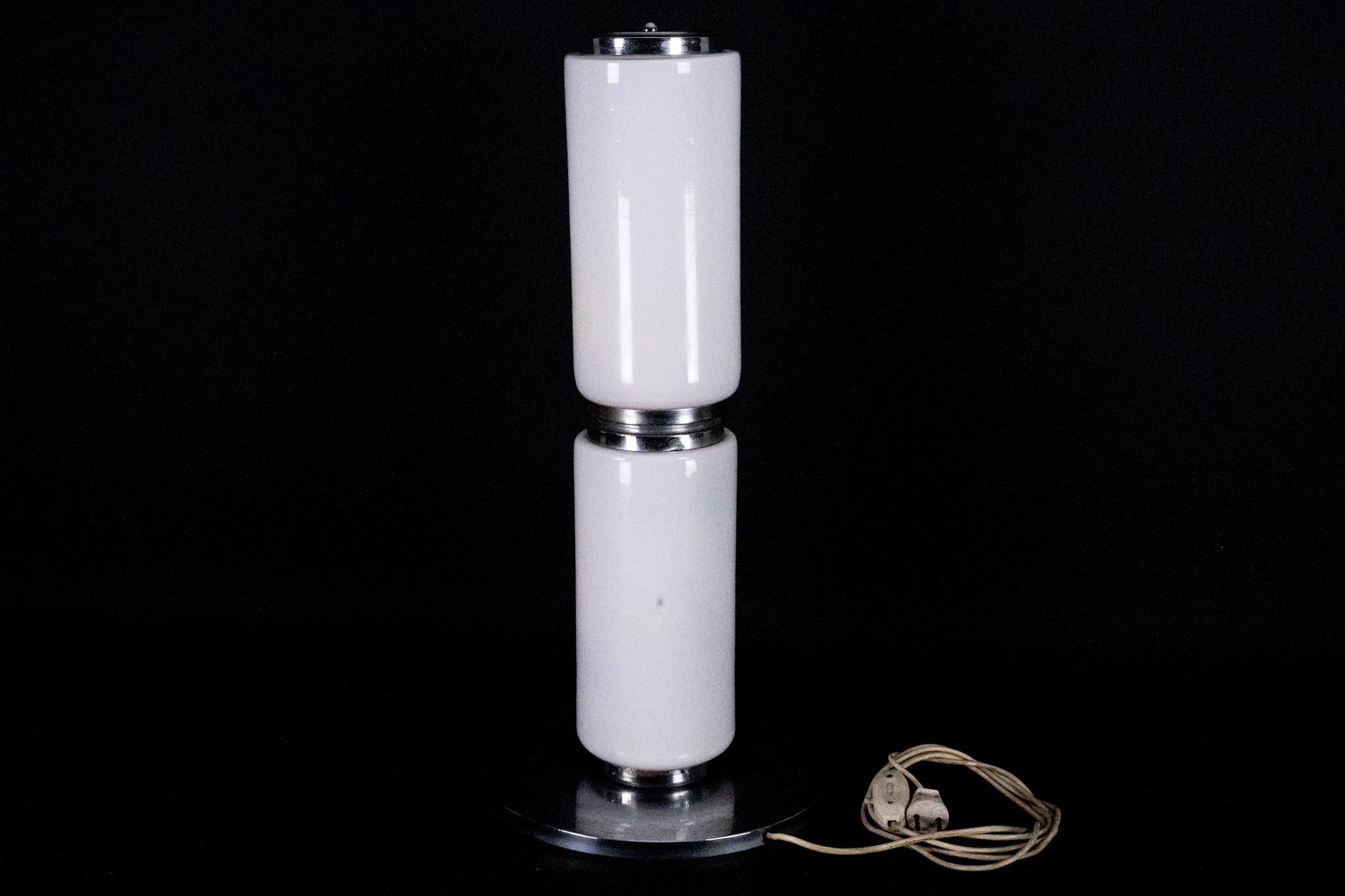 This vintage Murano glass floor lamp was crafted in Italy during the 1970s. It is distinguished by its two large, flawless cylindrical glass elements, both displaying the original Vetro di Murano - Made in Italy sticker. The lamp stands at