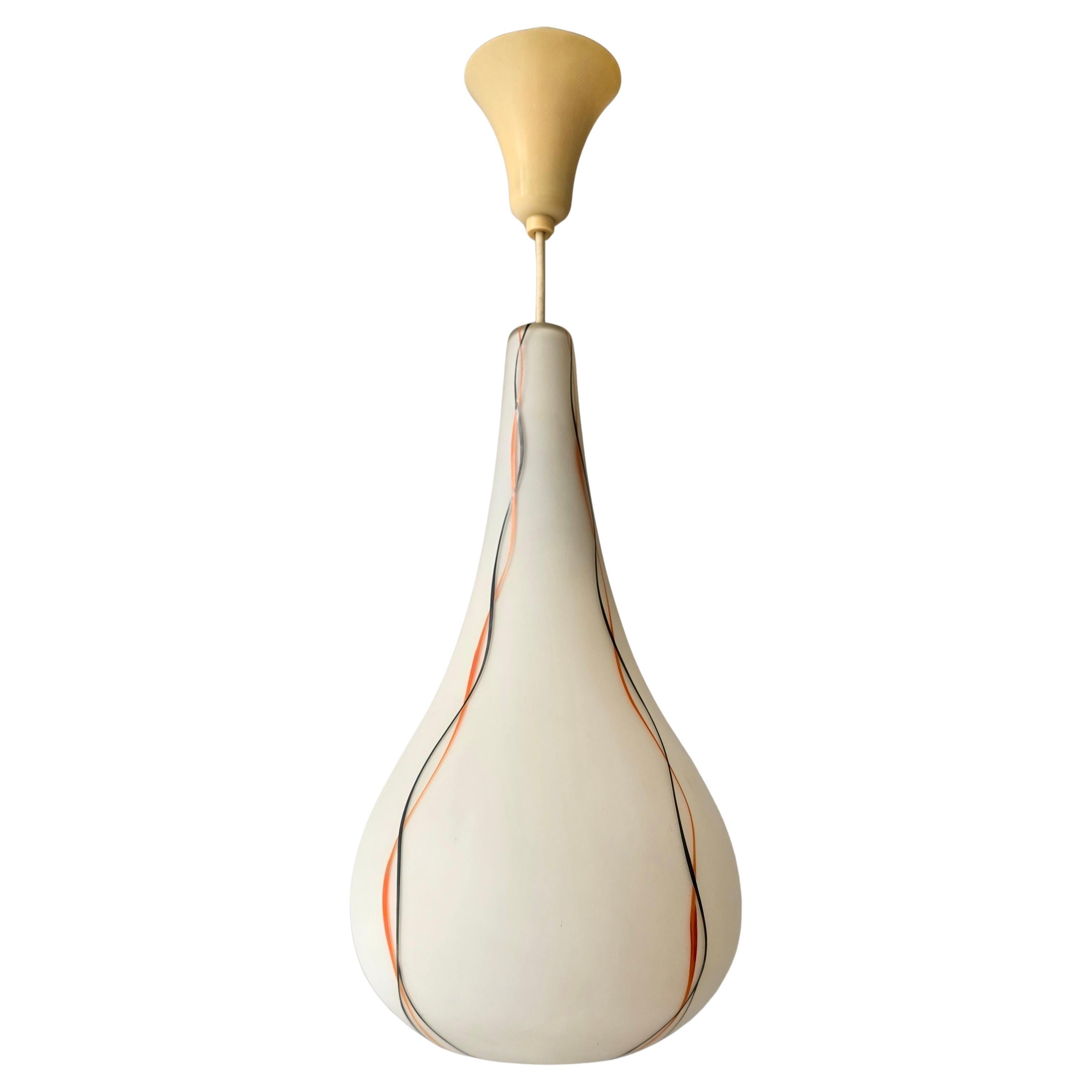 1970s Murano Glass Teardrop Pendant Light, Italy

Elegant Mid-Century Modern Murano glass pendant light, Italy, 1970s.
The lamp features a refined teardrop shape in satin white glass, decorated with orange and black ribbon swirls that run gracefully
