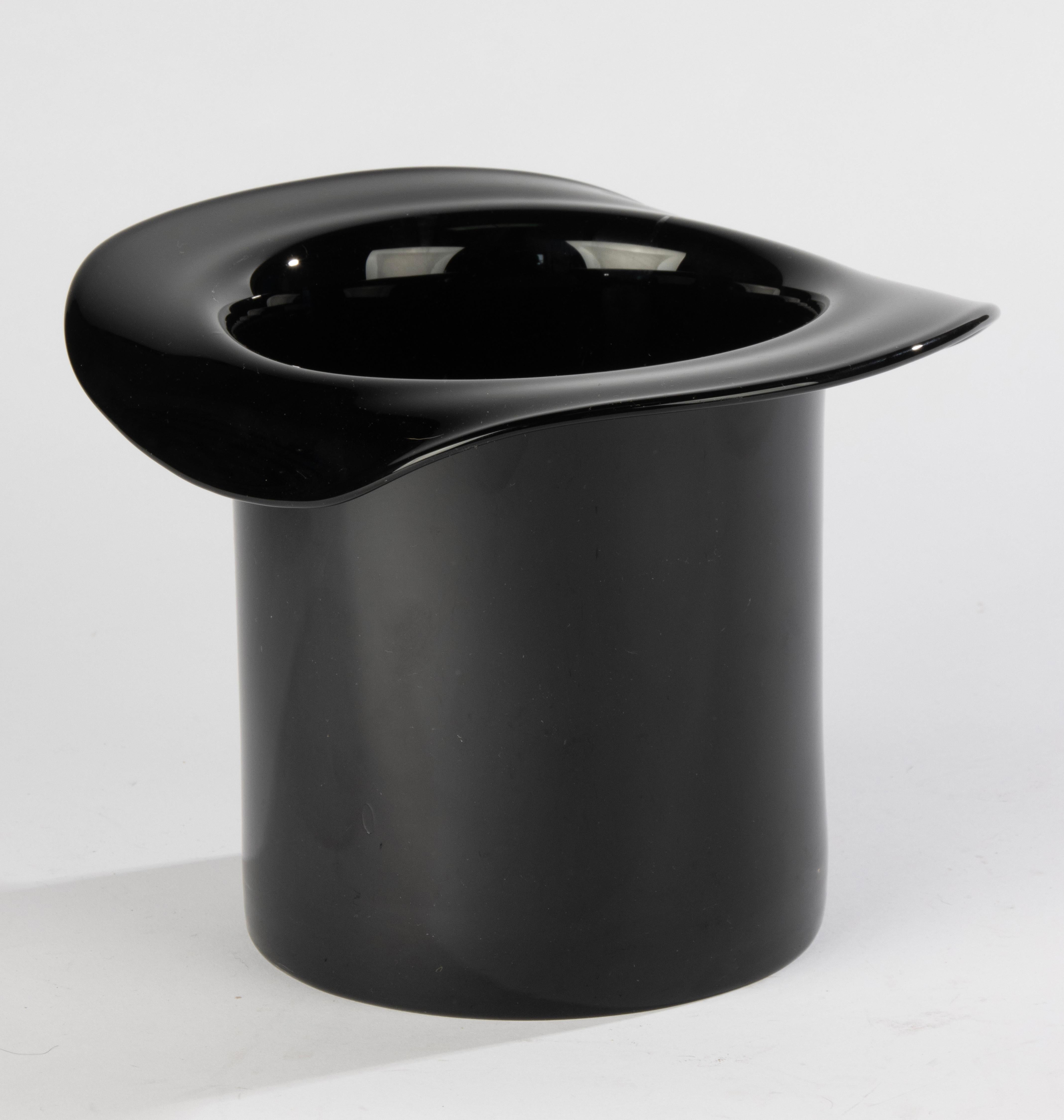 A playful and elegant wine cooler crafted in the form of a classic top hat. Likely of Murano origin, this striking piece is made of glossy black glass and exemplifies the whimsical yet refined design sensibility associated with Italian mid- to