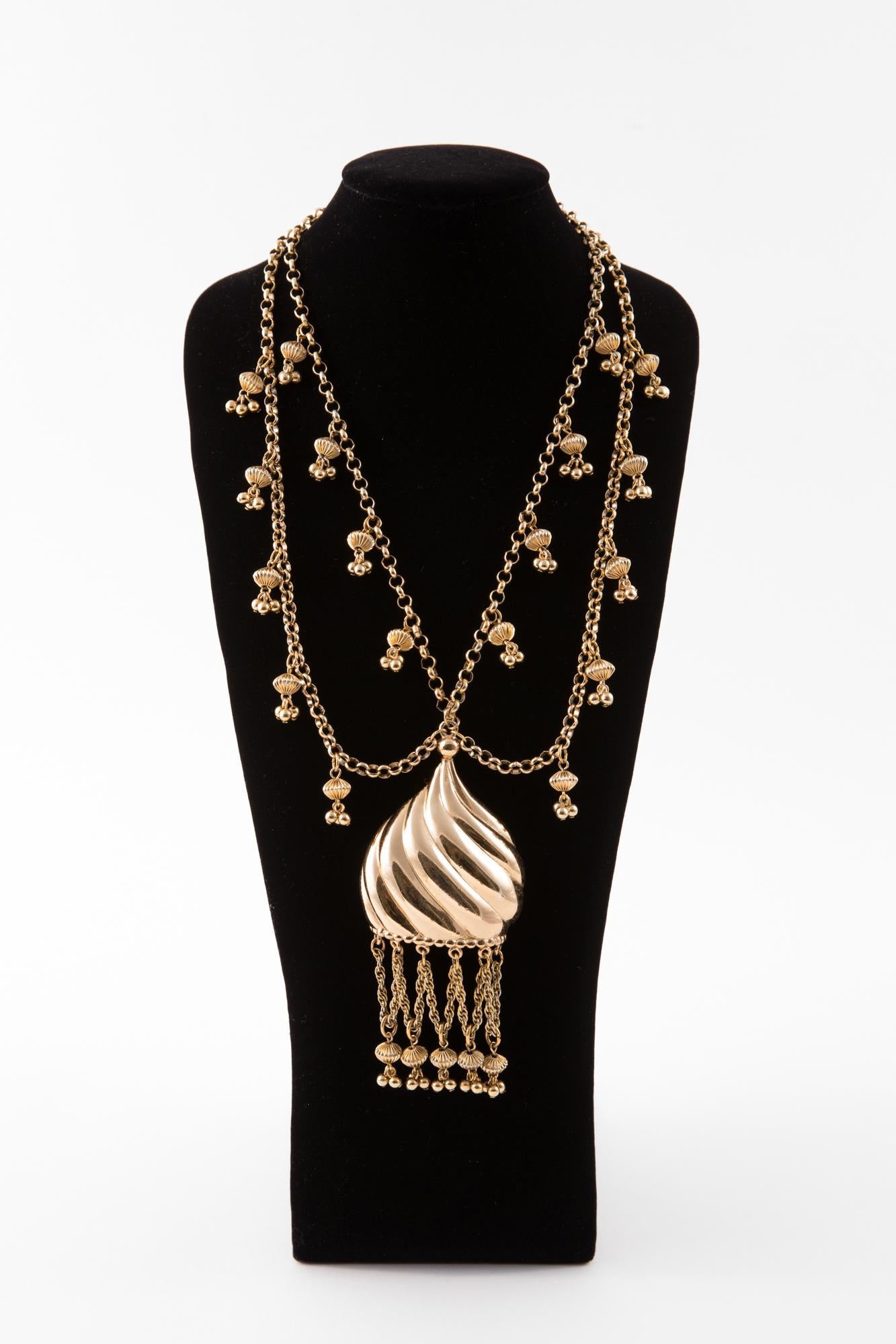 Napier gold tone necklace featuring two raws of chains,  a huge mobile pendant part with free chain and beads, a hook-clasp opening. 
The piece is signed twice, one on the back of the pendant and also on the hook-clasp of the necklace. 
In excellent