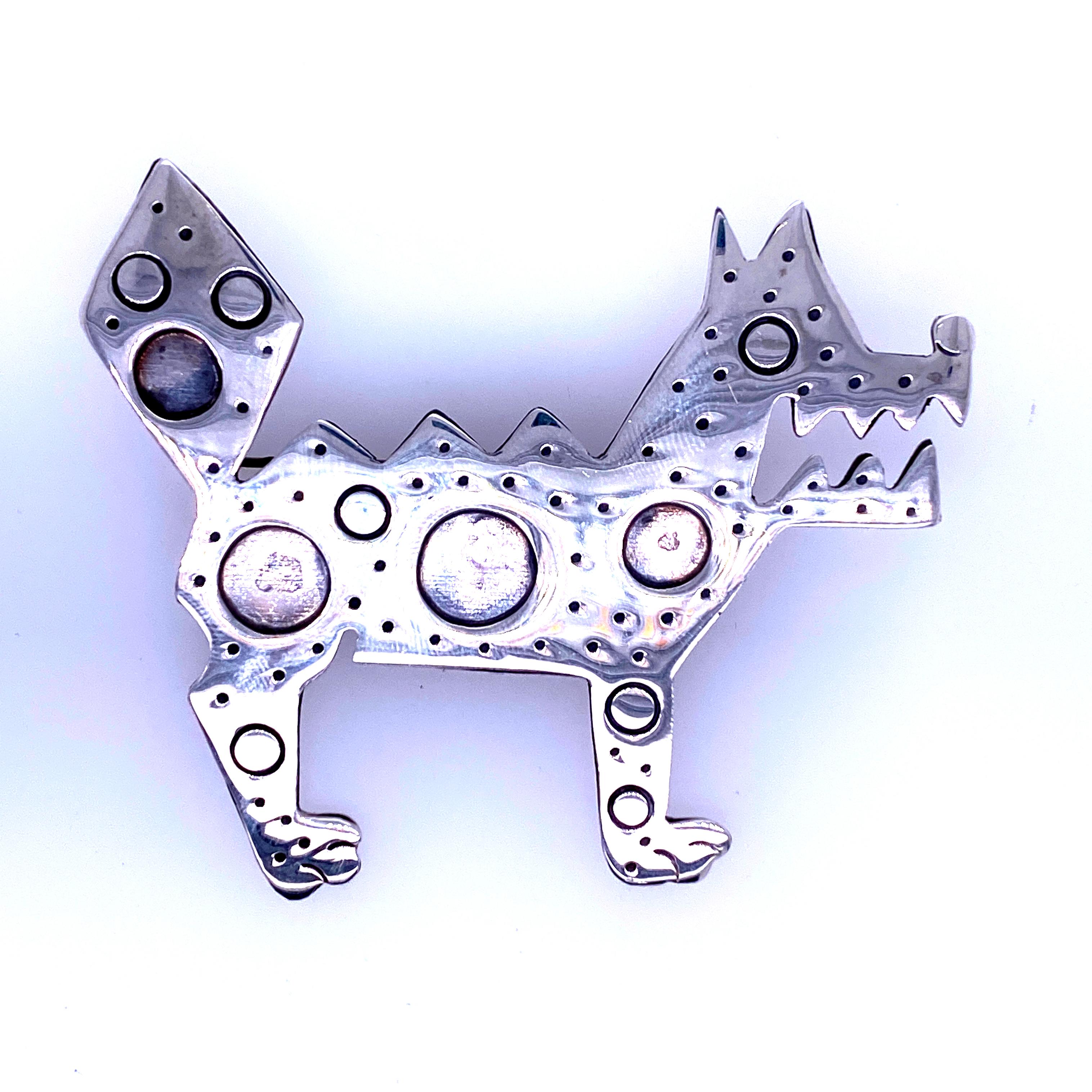 One sterling silver Mexican dog pin (stamped STERLING TR-94) measuring 2.5 inches long x 2.25 inches tall.  Circa 1970s. 