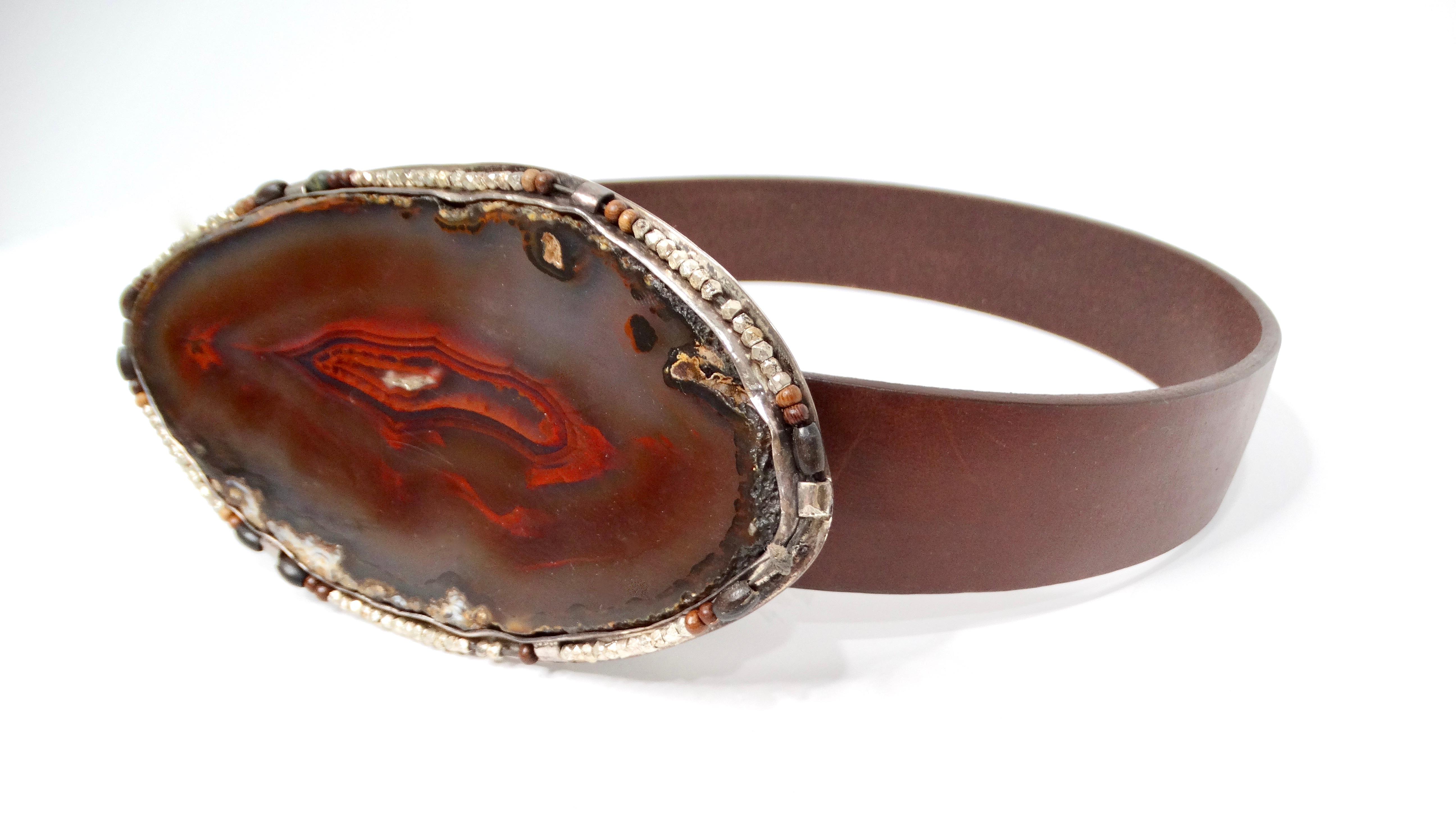 Experience the charm of the 1970s with this stunning Natural Brown Agate Beaded Detail Leather Belt. Featuring a large, eye-catching agate stone buckle surrounded by intricate small beads, this belt exudes a unique blend of natural beauty and