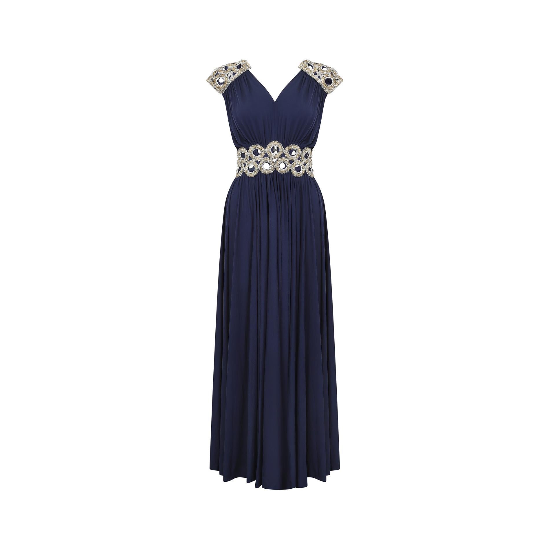This mid to late 1970s navy and sequin detail Grecian dress is a show stopping unlabelled couture piece.  It is skilled work and has mostly been made by hands trained in haute couture techniques.  The designer that immediately springs to mind is