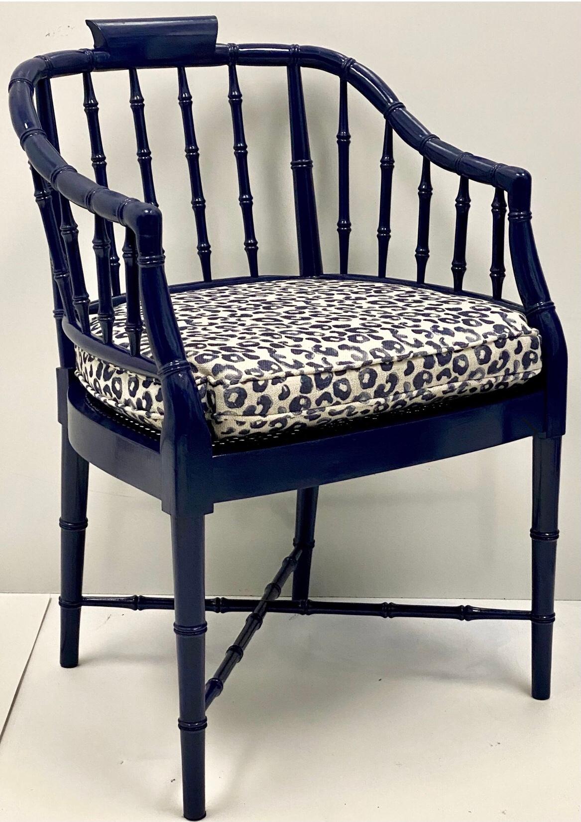 This is a pair of 1970s navy lacquered faux bamboo barrel chairs with leopard fabric cushions. The upholstery is recent, and they are in very good condition.