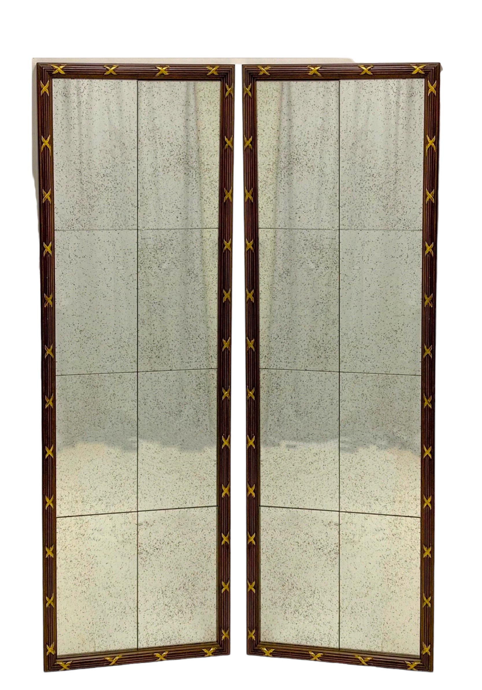 This is a pair of tall neo-classical style mirrors. The glass is intentionally distressed. The carved frame appears to be mahogany with gilt accents. They are unmarked.
